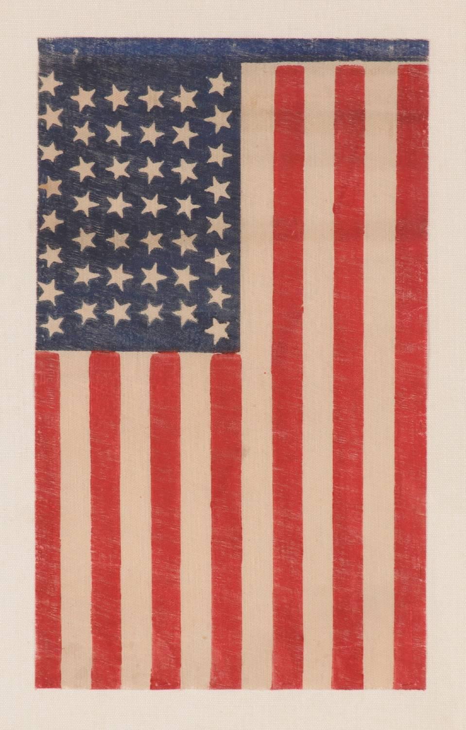 44 tumbling stars in an hourglass formation, on an antique American parade flag of the 1890-1896 period, reflects Wyoming statehood: 

44 star American parade flag, printed on coarse, glazed cotton. The stars are configured in rows of 8-7-7-7-7-8,