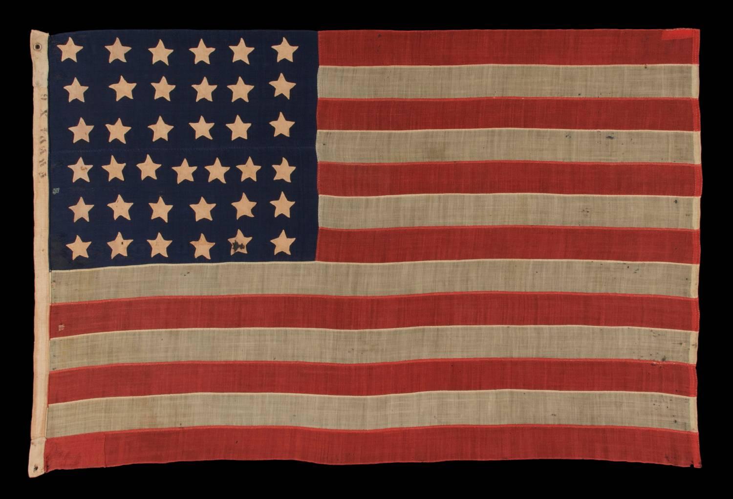 37 single appliquéd stars on an antique American flag made during the reconstruction era, during the Indian wars, between 1867-1876, when Nebraska was the most recent state to join the union:

 37 hand-sewn, single-appliquéd stars and 13 hand-sewn