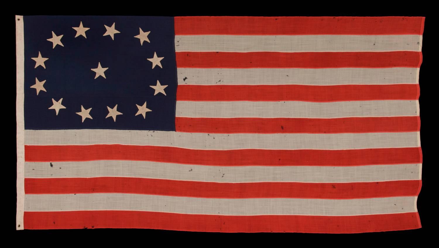 13 HAND-SEWN STARS, IN AN OVAL VERSION OF THE 3RD MARYLAND PATTERN, ON AN ANTIQUE AMERICAN FLAG MADE IN THE PERIOD BETWEEN THE CIVIL WAR (1861-65) AND THE 1876 CENTENNIAL OF AMERICAN INDEPENDENCE:

13 star flags have been flown throughout our