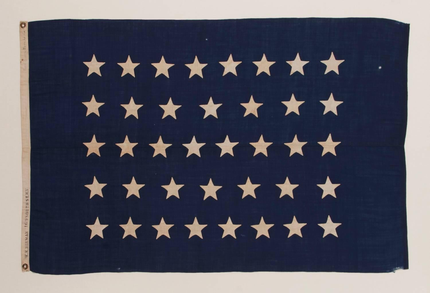 ANTIQUE AMERICAN U.S. NAVY JACK WITH 38 HAND-SEWN STARS AND A RARE MAKER'S MARK OF FLAG AND SAILMAKER W. K. HINMAN OF NEW YORK CITY, FLOWN ON THE YACHT 