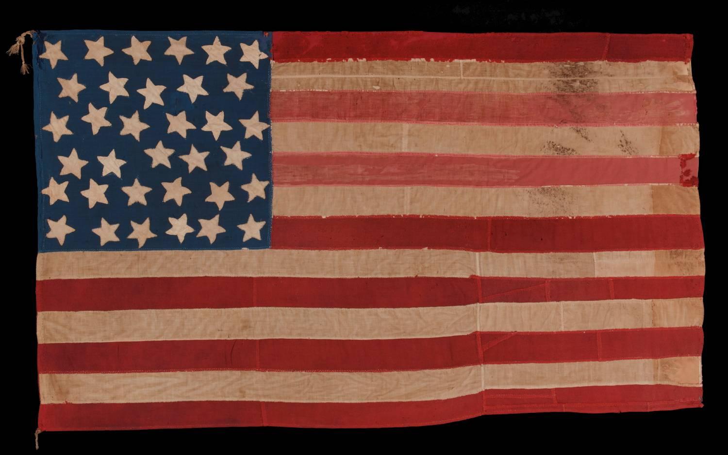 34 star, hand-sewn, homemade, antique American flag of the civil war period, made of a combination of salvaged fabrics, including mens shirting, 1861-1863, opening years of the war, reflects the addition of Kansas :

Homemade American national