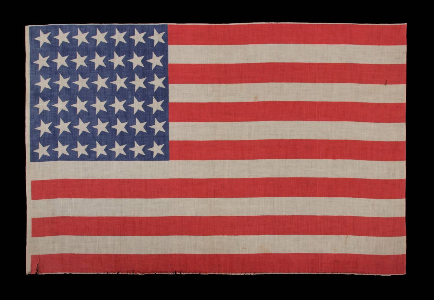 42 canted stars, never an official star count, 1889-1890, Washington statehood:

 42 star American parade flag, printed on cotton. Note how the stars, which are arranged in a rectilinear fashion, are canted at a uniform angle in the 11:00