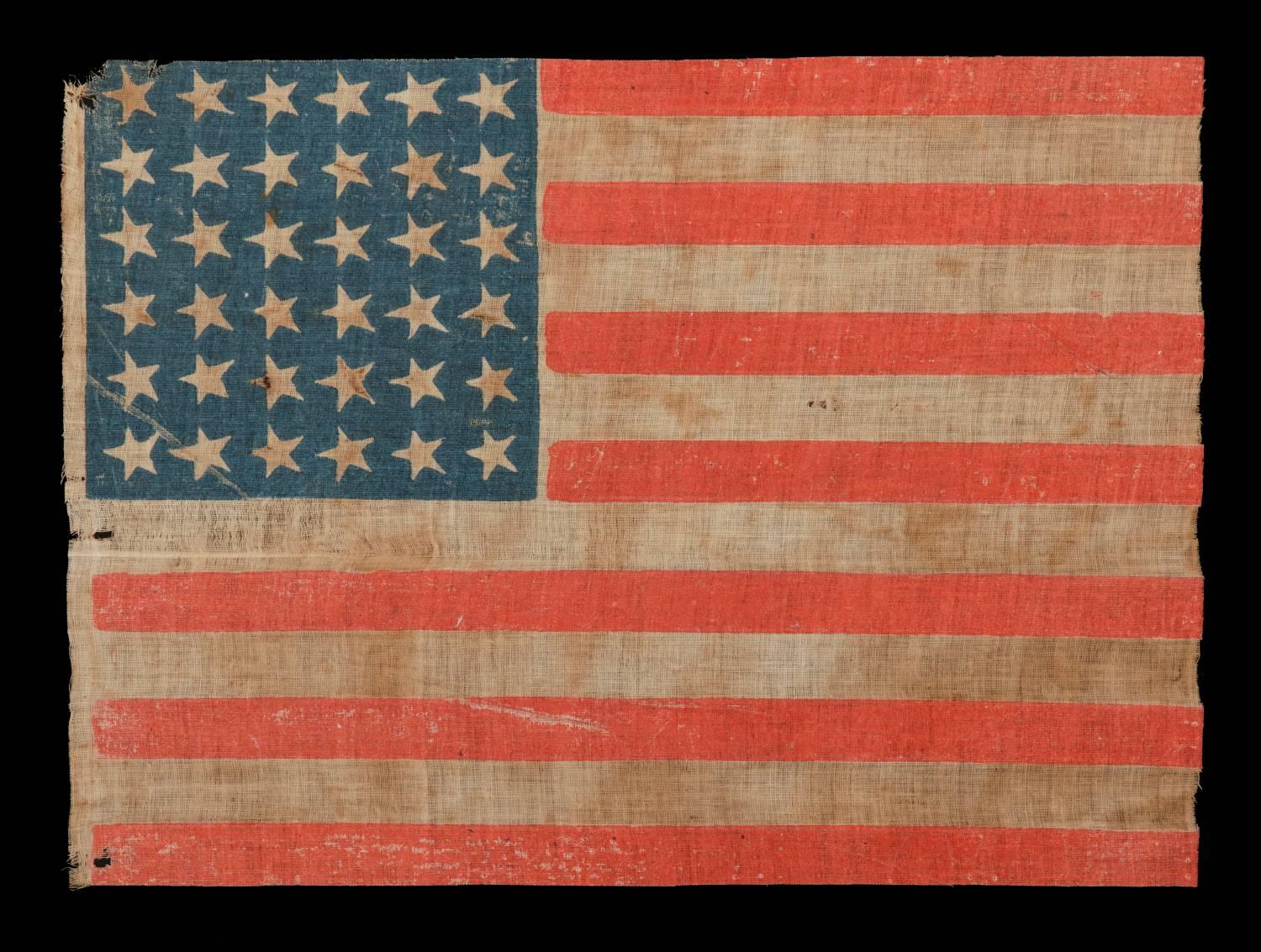 36 star antique American Parade flag of the Civil War era, an attractive example with endearing wear, nice colors and canted stars, 1864-67, Nevada Statehood:

 36 star American national flag of the Civil War era, printed on coarse, glazed cotton.
