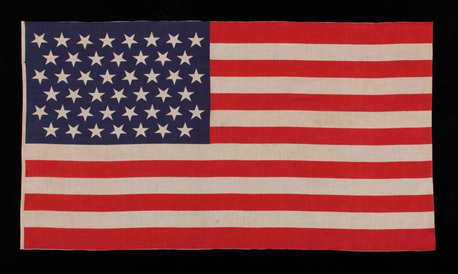 45 STARS IN LINEAR ROWS, WITH “DANCING” OR “TUMBLING” ORIENTATION, ON A LARGE SCALE PARADE FLAG WITH AN ELONGATED PROFILE, 1896-1908, SPANISH-AMERICAN WAR ERA, UTAH STATEHOOD: 

45 star American national parade flag, printed on cotton bunting. The