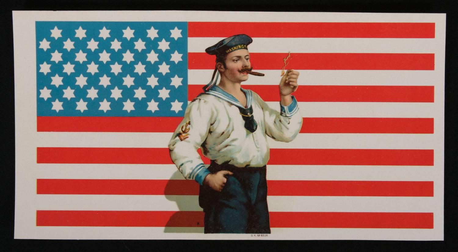 CIGAR BOX LABEL WITH IMAGE OF A 42-STAR AMERICAN FLAG WITH SIX-POINTED STARS AND IT'S BLUE CANTON RESTING ON THE WAR STRIPE, AND AN IMAGE OF A SAILOR LIGHTING A CIGAR, 1889-1920: 

This interesting, late 19th or early 20th century (ca 1889-1920)