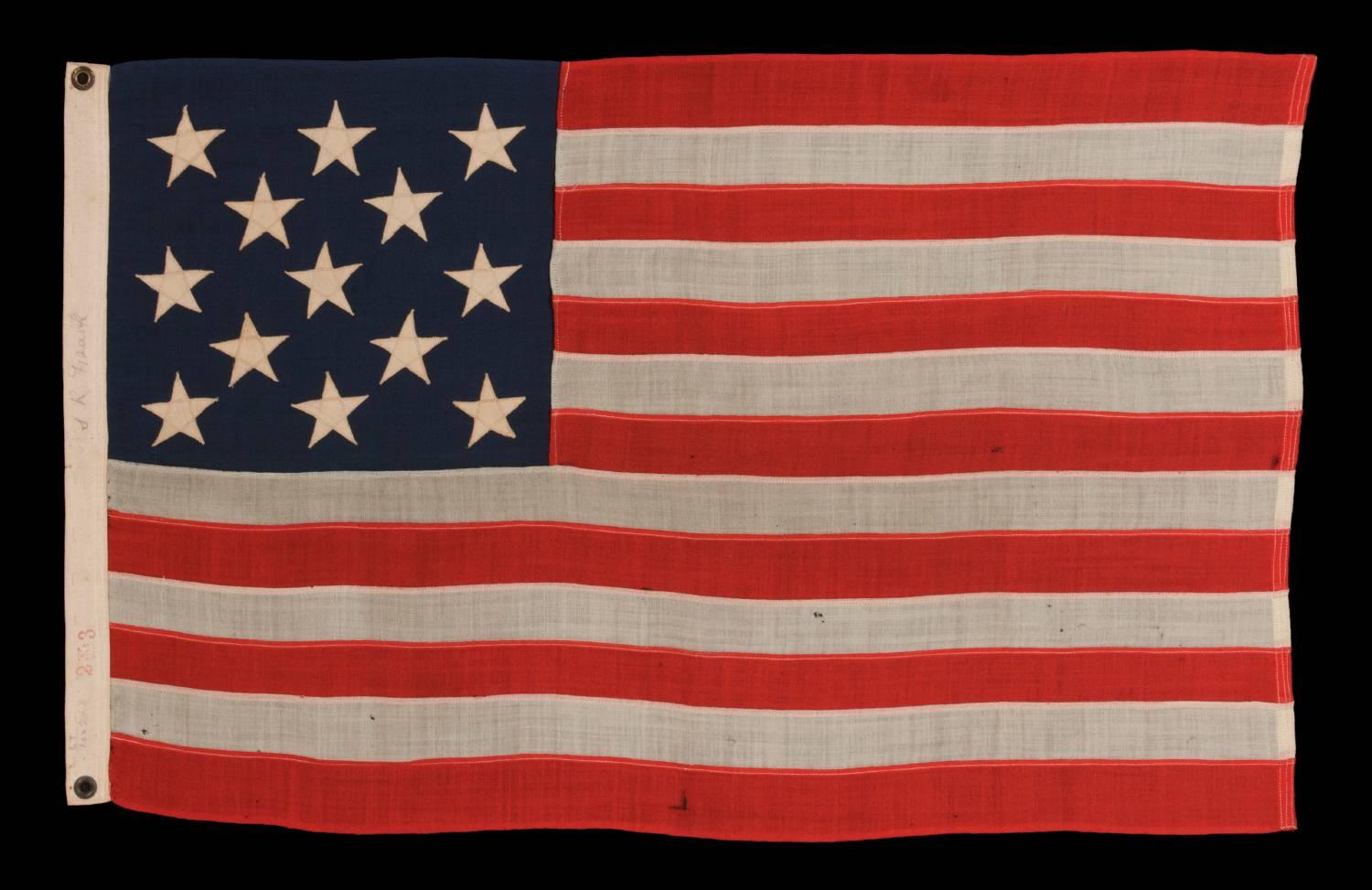13 stars arranged in A 3-2-3-2-3 Pattern on a small-scale antique American flag made in the period between the last decade of the 19th century and the first quarter of the 20th century:

This 13 star antique American flag is of a type made during