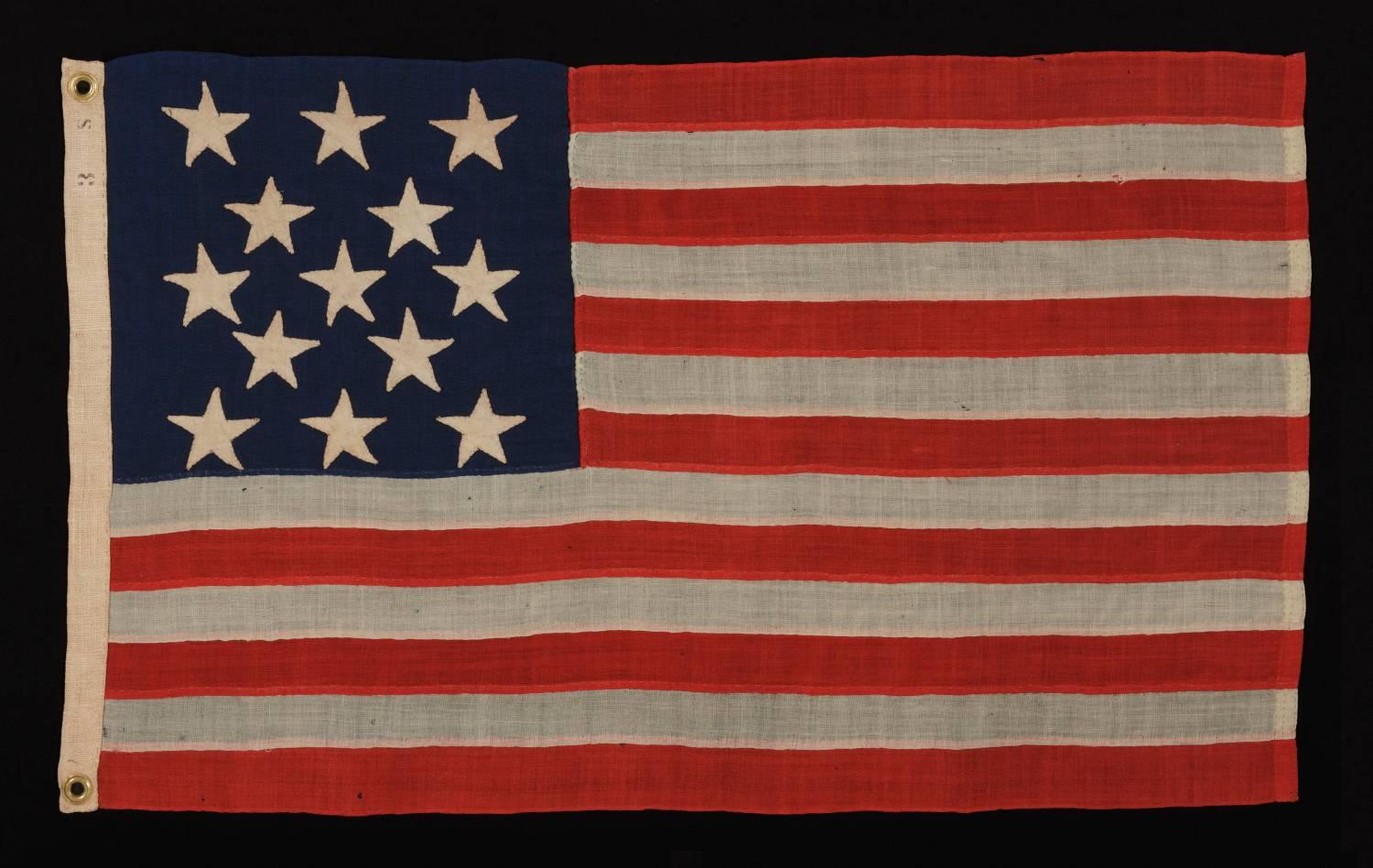 13 hand-sewn, single-appliquéd stars, likely made by Annin & Co. In New York city, in a rare, small size among known flags with sewn construction, 1861-1876 era, probably designed for use as a camp colors or in some other military function: