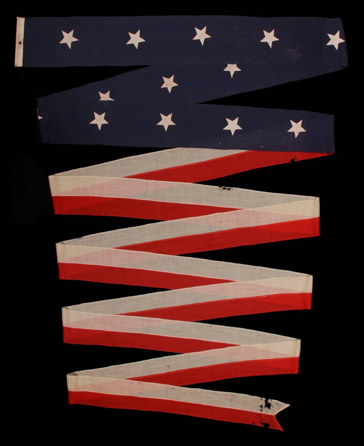 U.S. NAVY COMMISSION OR HOMEWARD-BOUND PENNANT WITH 14 STARS, MADE BY E.L. ROWE AND SONS OF GLOUCHESTER, MASSACHUSETTS, MADE CA 1890-1909, WITH VERBAL HISTORY OF USE IN TEDDY ROOSEVELT'S GREAT WHITE FLEET 

 Commission pennants are the