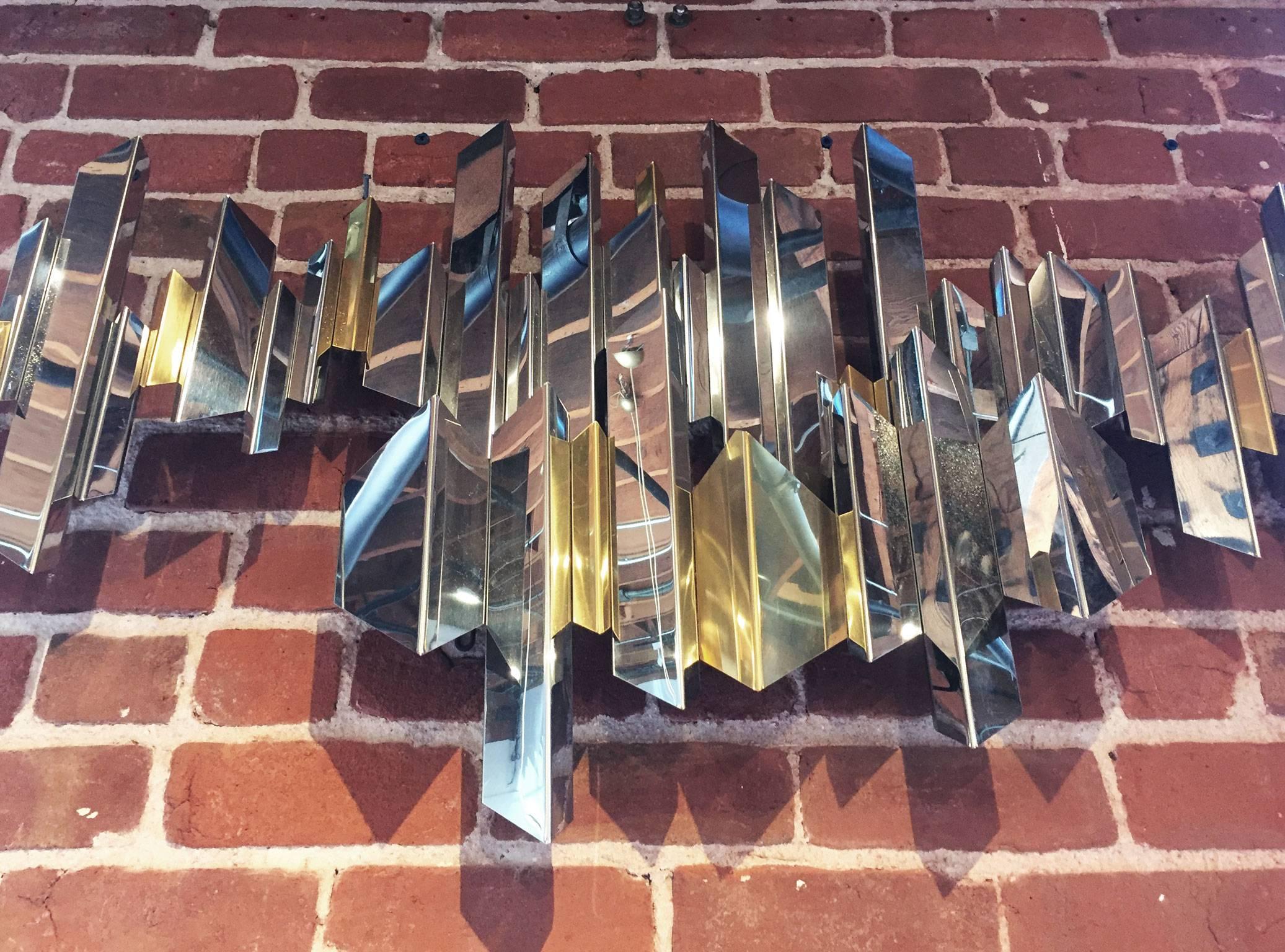 A Chrome And Brass Faceted Wall Sculpture By Curtis Jere.