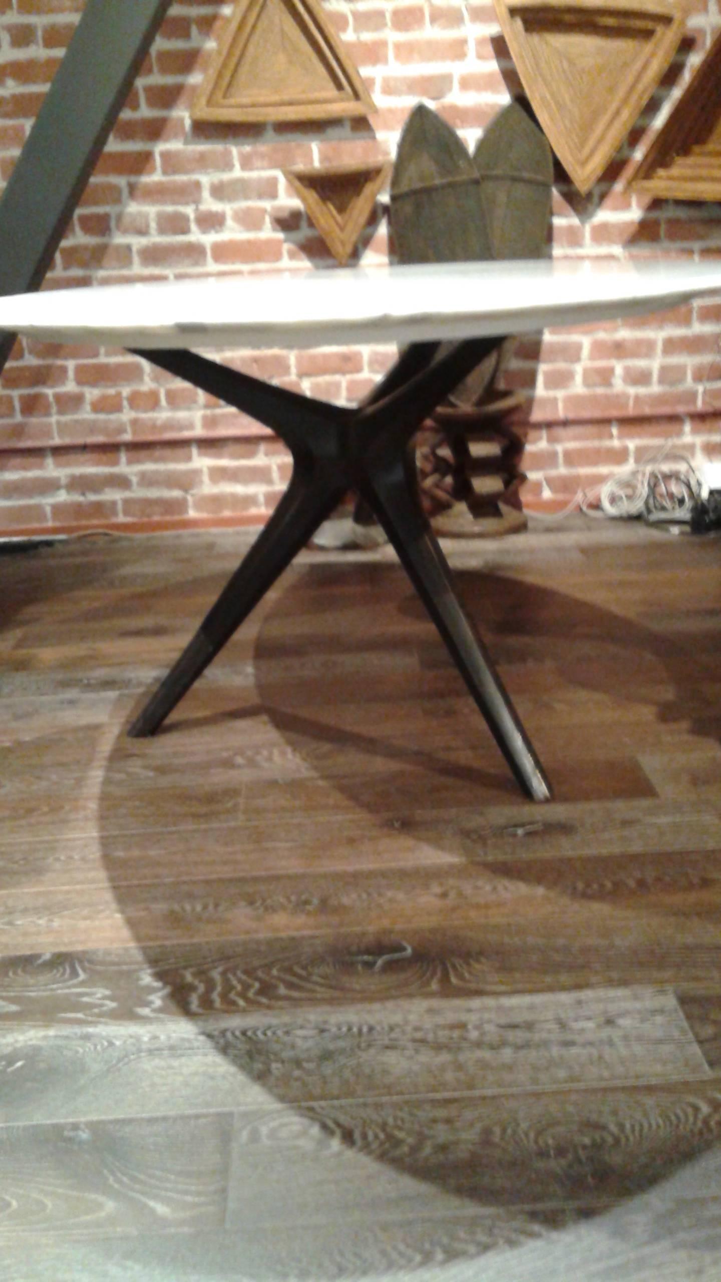Large oval tabletop on a dark metal tripod base. Some chips to the edge.