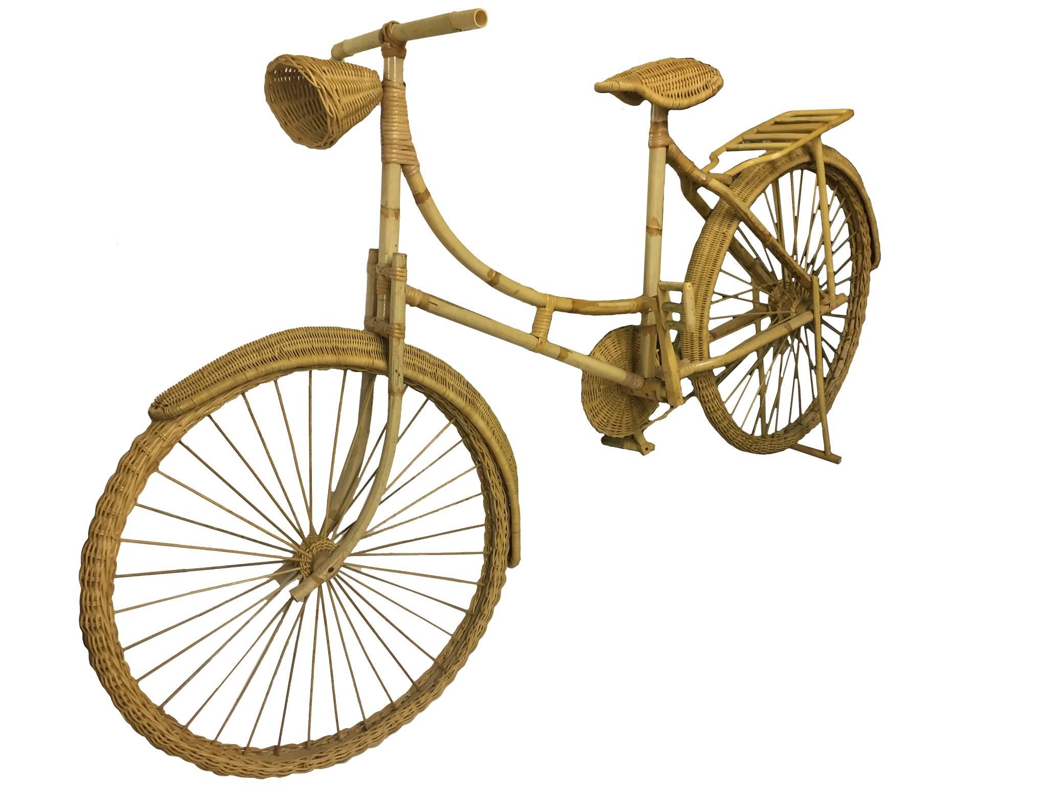 Old Fashioned Bike made out of wicker and bamboo. Hand crafted in 20th century. The bike is full size and has pedals, rack, kickstand, and headlight.