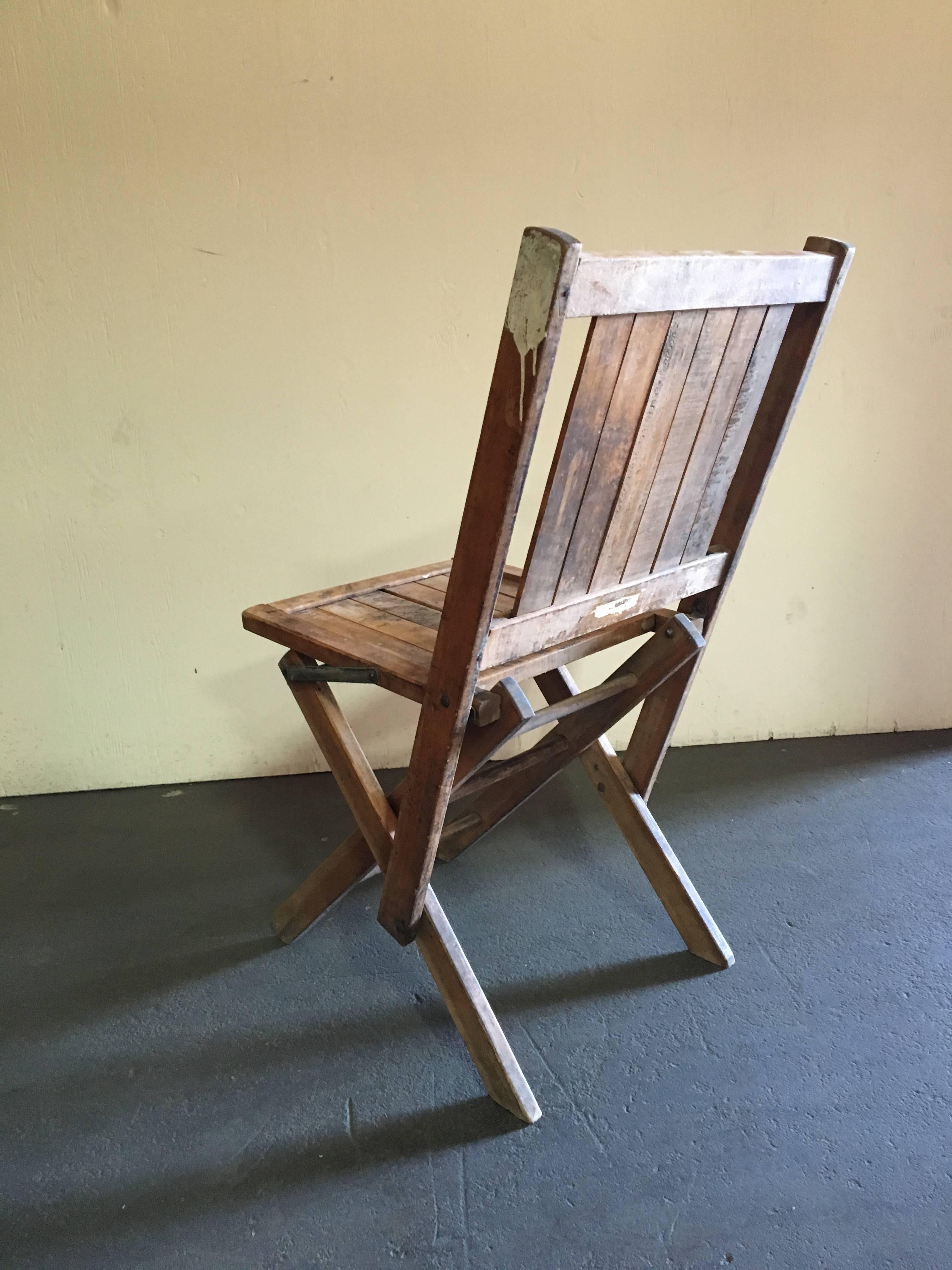 A set of six natural wood slat folding chairs with square seats and square backs.

Quantity: 6.