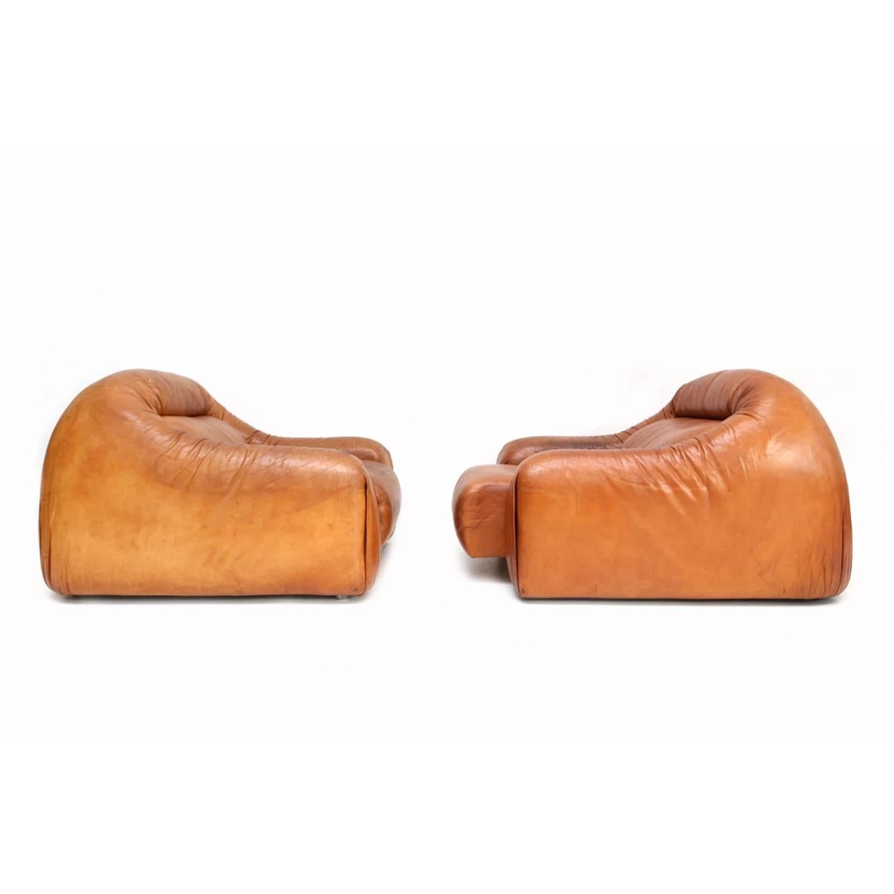 Unique low leather club chairs. Light aged tan leather with flat base.
Sold as a pair.