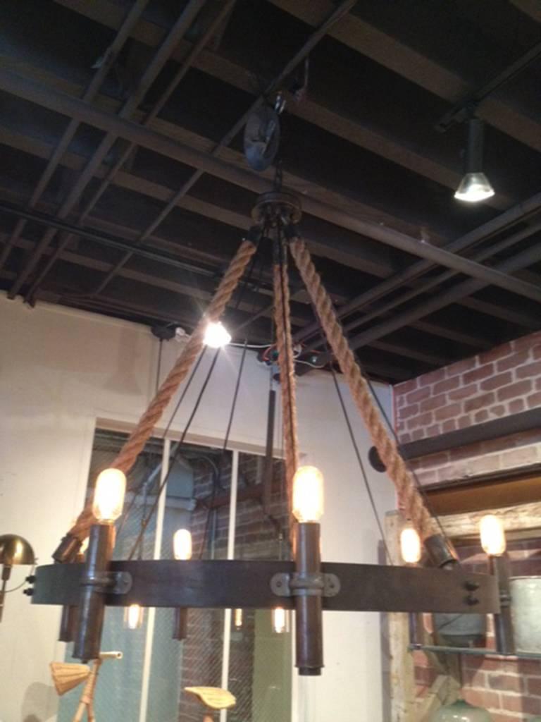A handsomely used wagon wheel turned into a chandelier.