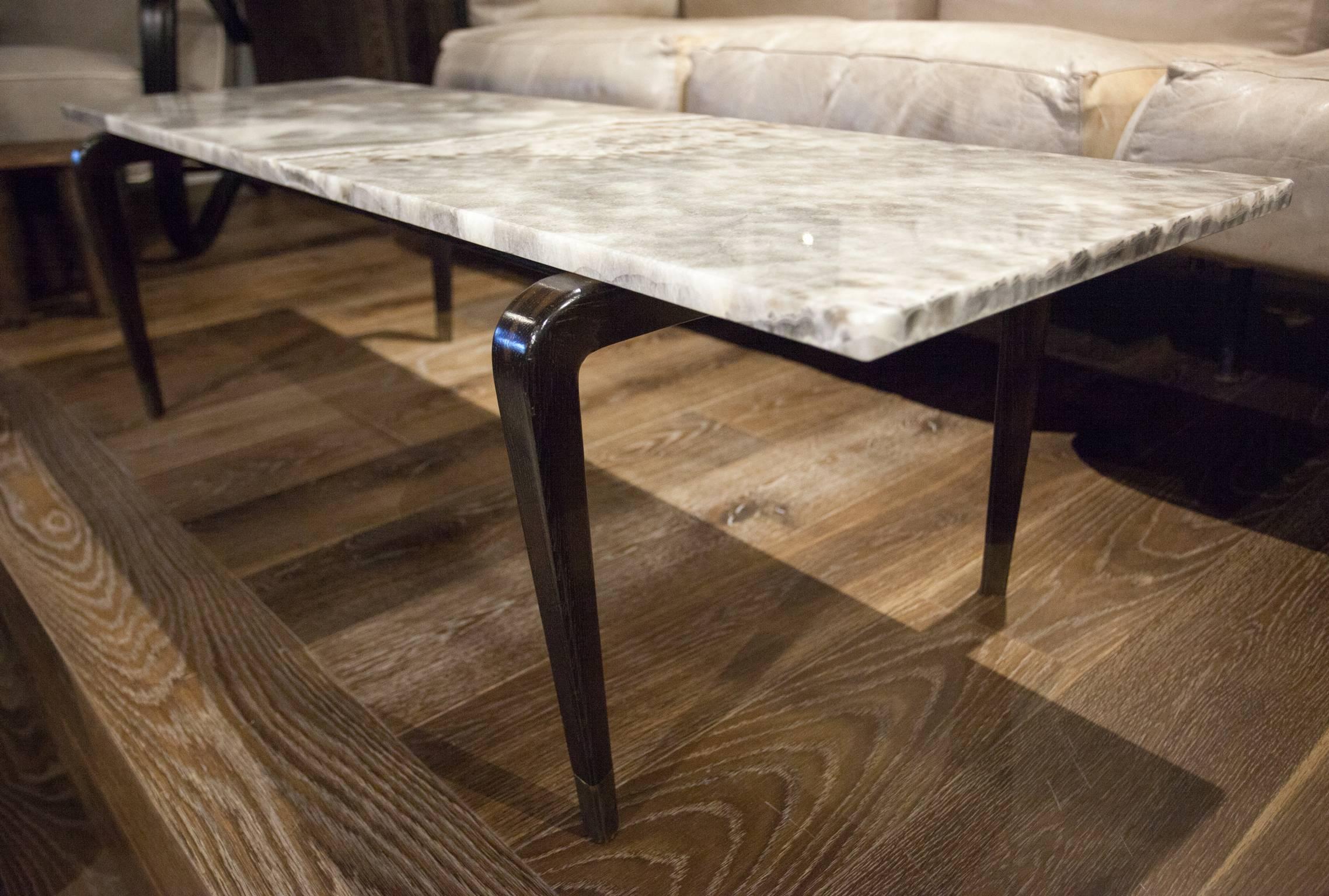 A custom coffee table with dark wood legs and a sleek onyx top, design by San Francisco designer Will Wick. Onyx top is removable.
 