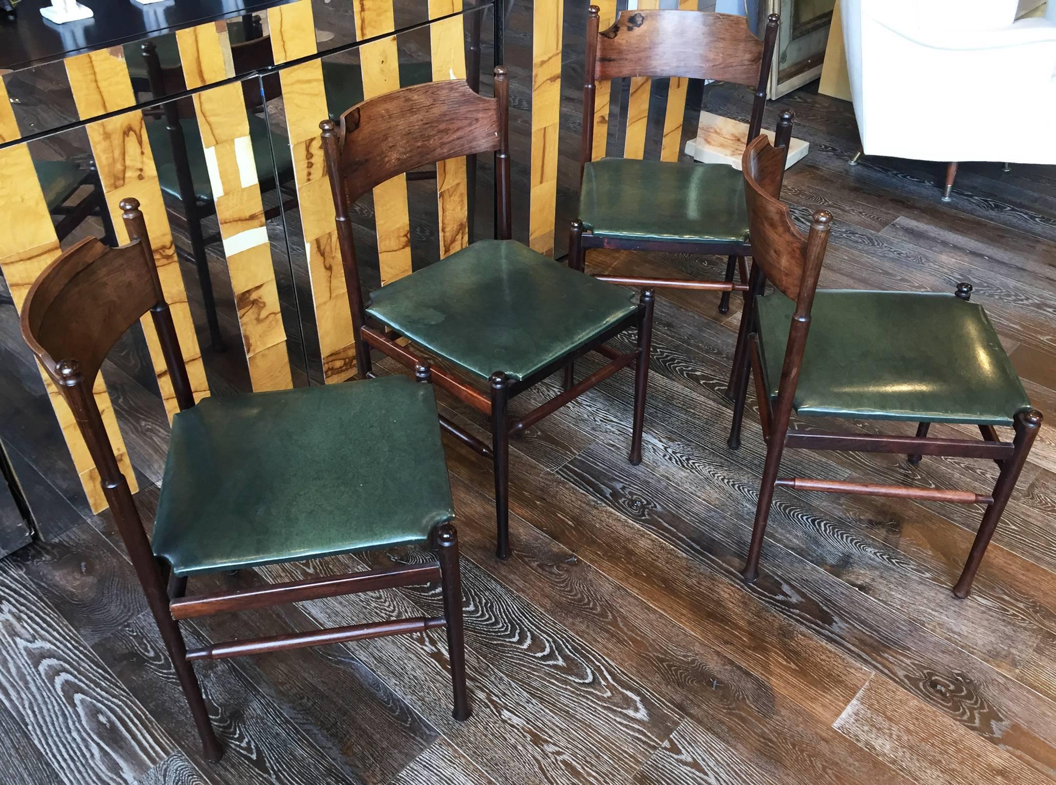 A very good set of four Gianfranco Frattini rosewood chairs having shaped backs over upholstered seats, circa 1955. Supported on turned legs. Sold as a set.
