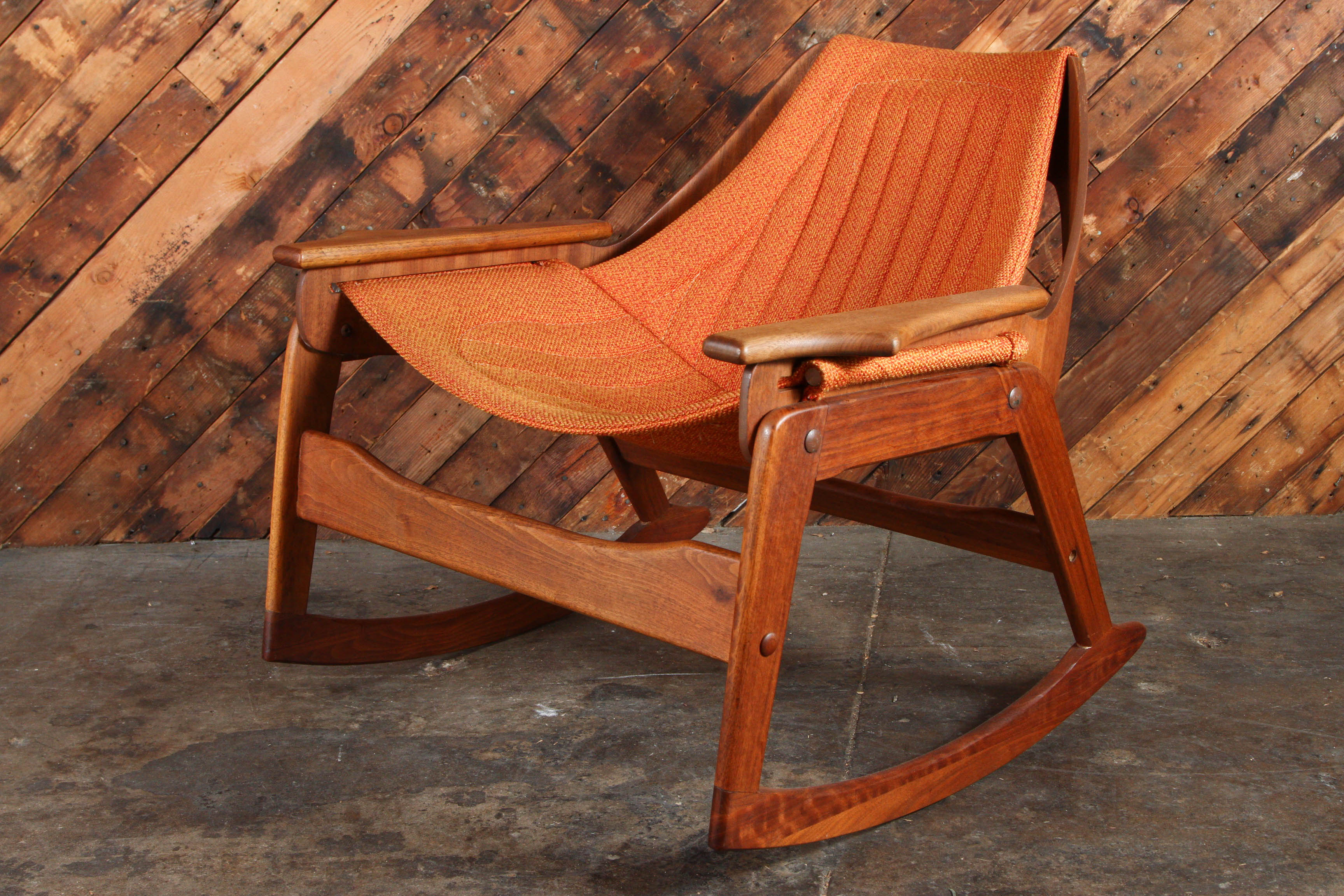 Rare bentwood Jerry Johnson Mid Century Walnut Rocking Chair with original nubby orange fabric. Very sturdy and comfortable. Circa 1964