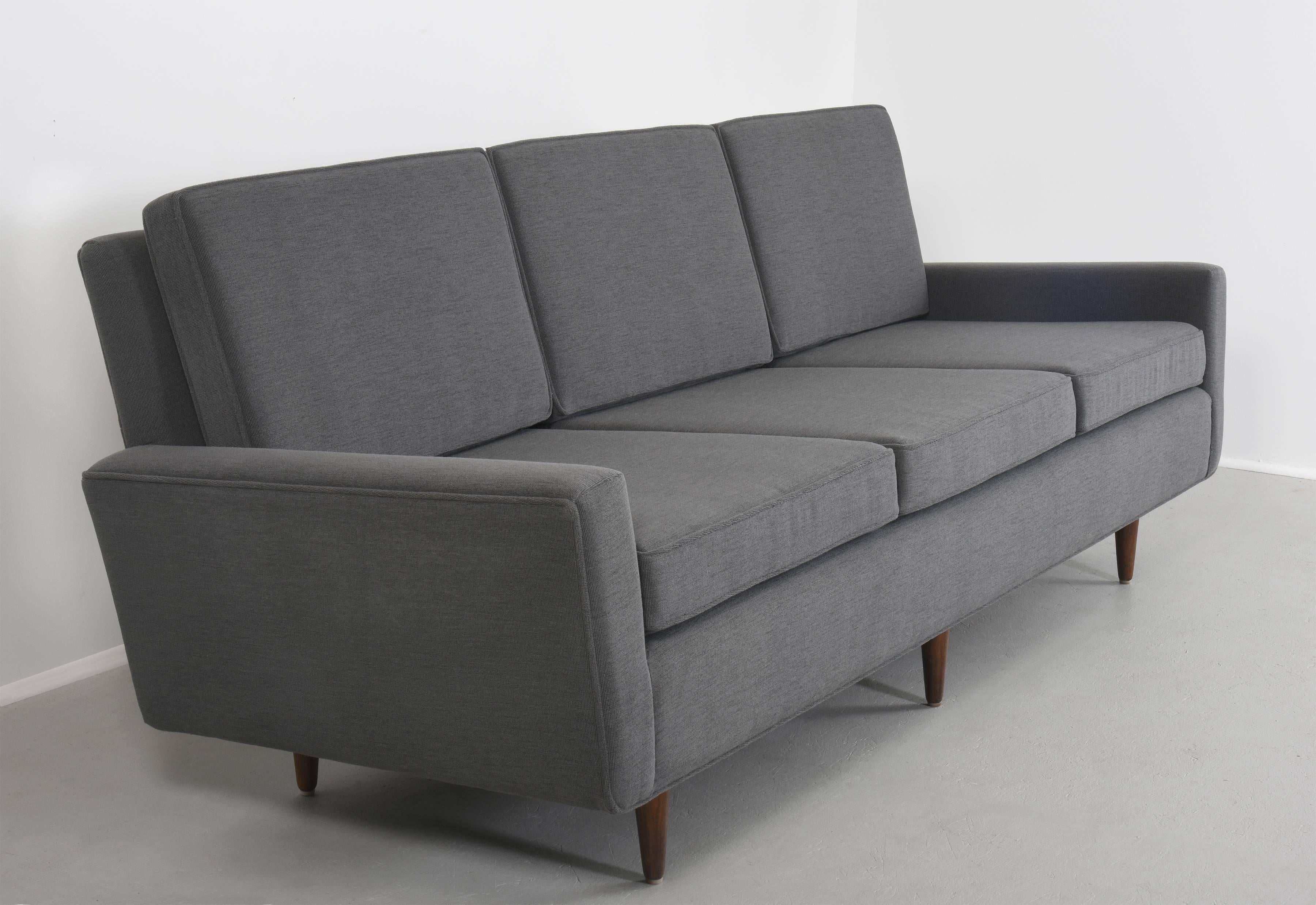 Florence Knoll sofa three-seat sofa with birch base
Model 26 circa 1947

Matched pair available from single estate ownership

Measures
32 H x 90 W x 32 D inches 
height includes cushions

Dark blue upholstery with birch base
 