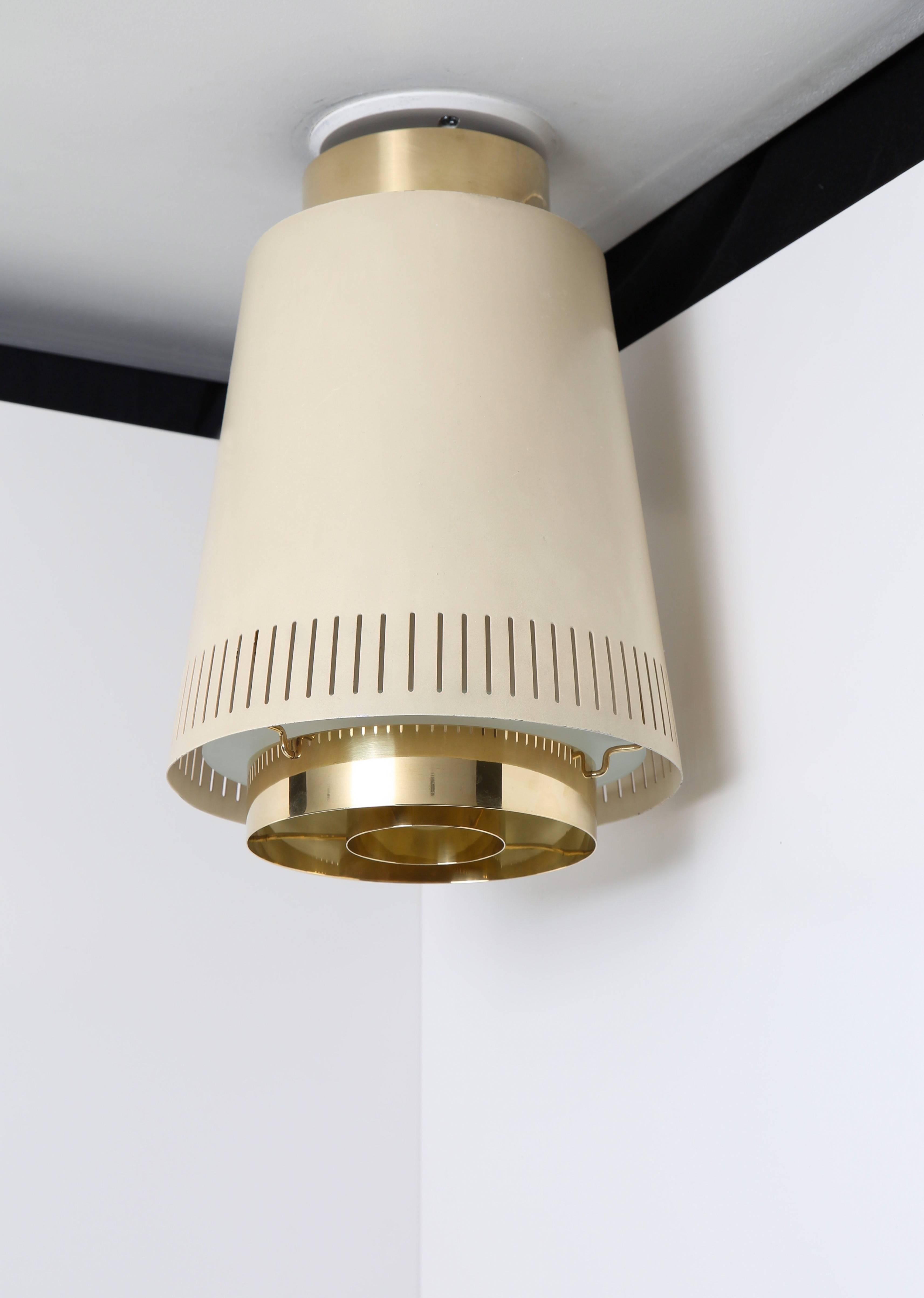 Pair of mounted ceiling lamps by Paavo Tynell, model no. 9067. 

Finland, circa 1950s. 
One item impressed with manufacturer's mark [Idman]. 

Brass, off-white painted metal with frost glass diffuser.

Height 33 x diameter 23 cm.
12.9 H x 9