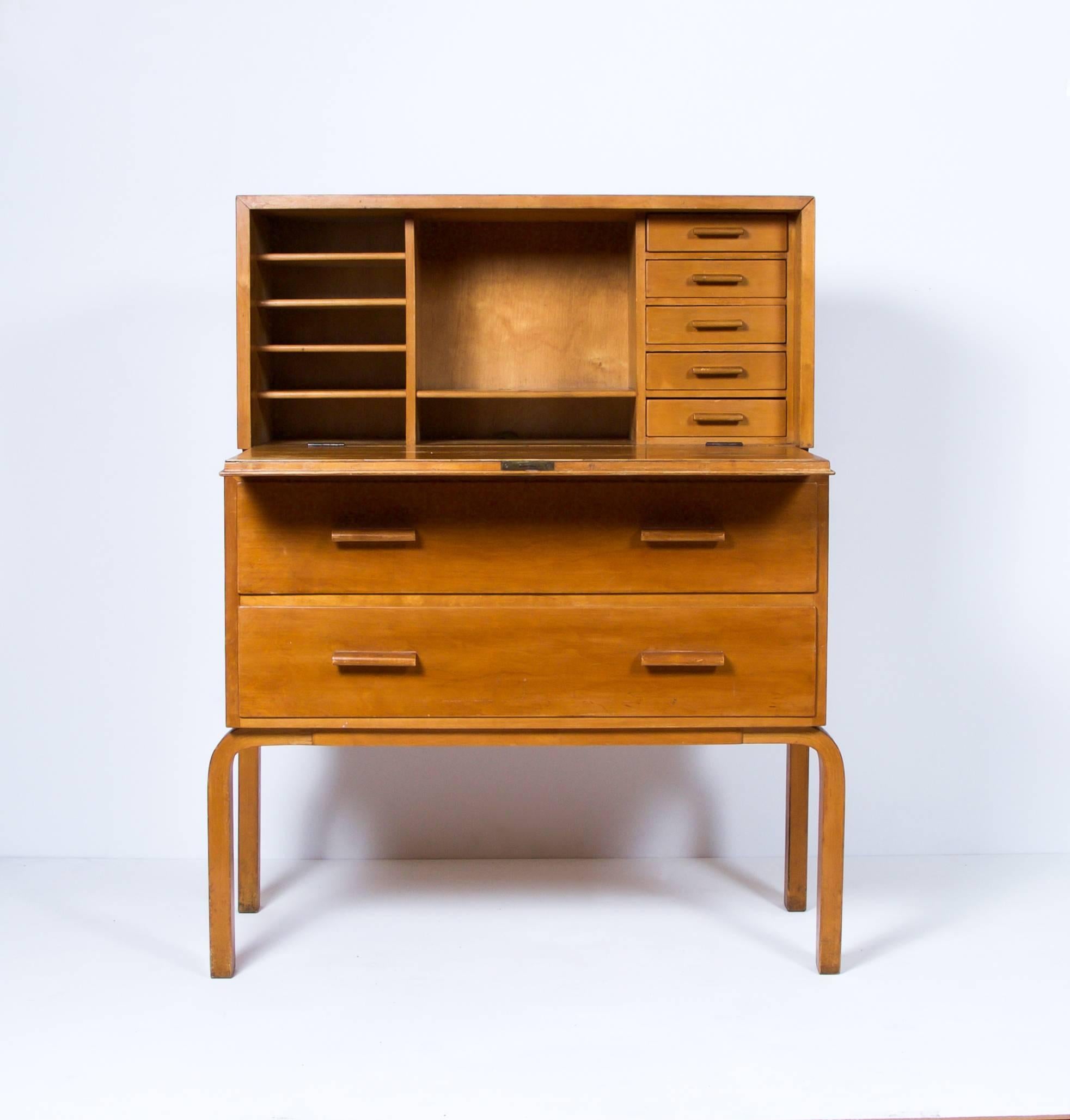 Rare early edition secretary by architect Alvar Aalto with L-legs in original condition.

Drop front desk with five small interior drawers and shelves. Below, two drawers,

Finland, circa 1930s.
Manufactured by Oy Huonekalu- ja