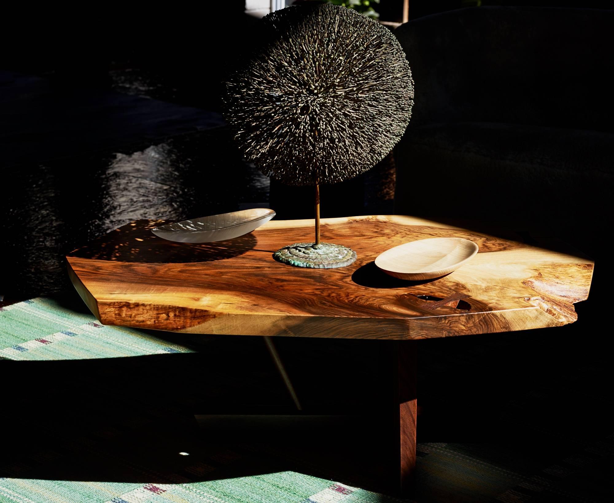 George Nakashima 

Minguren II coffee table.

Nakashima Studio.
English walnut and rosewood.
Measures: 16 H x 44 W x 30 D inches.

Rare wood selection, highly figured, single slab English walnut on a solid, old growth, rosewood base. Signed