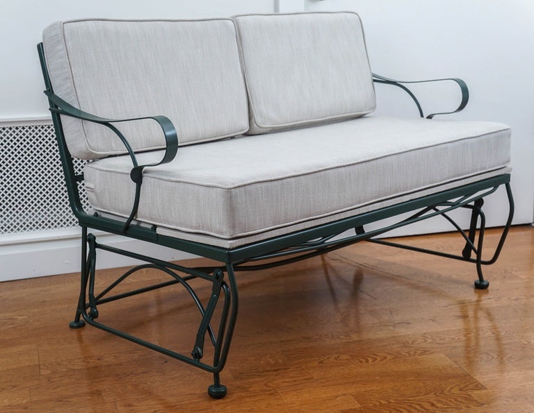 midcentury, newly painted, wrought iron glider, with newly made cushions.
upholstered in a fresh beige and ivory striated, weather resistant fabric.
guaranteed, sitting on this glider, will bring back fond childhood memoirs!
pairs nicely with