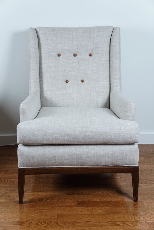 chic, lounge chair, designed by T.H. Robsjohn Gibbings, for Widdicomb.
newly upholstered in a pleasing, oatmeal linen fabric, with irresistible, leather covered buttons.