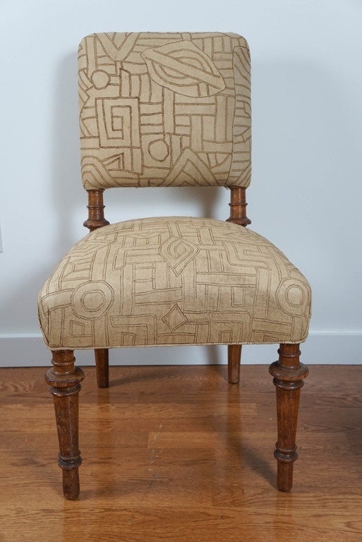stunning! antique oak side chair, with turned legs.
newly upholstered, in vintage Kuba cloth. this magnificent, embroidered, and appliqued fabric, is made by the talented Kuba artisans of the Congo.
they hand cut, dye and weave strips from the