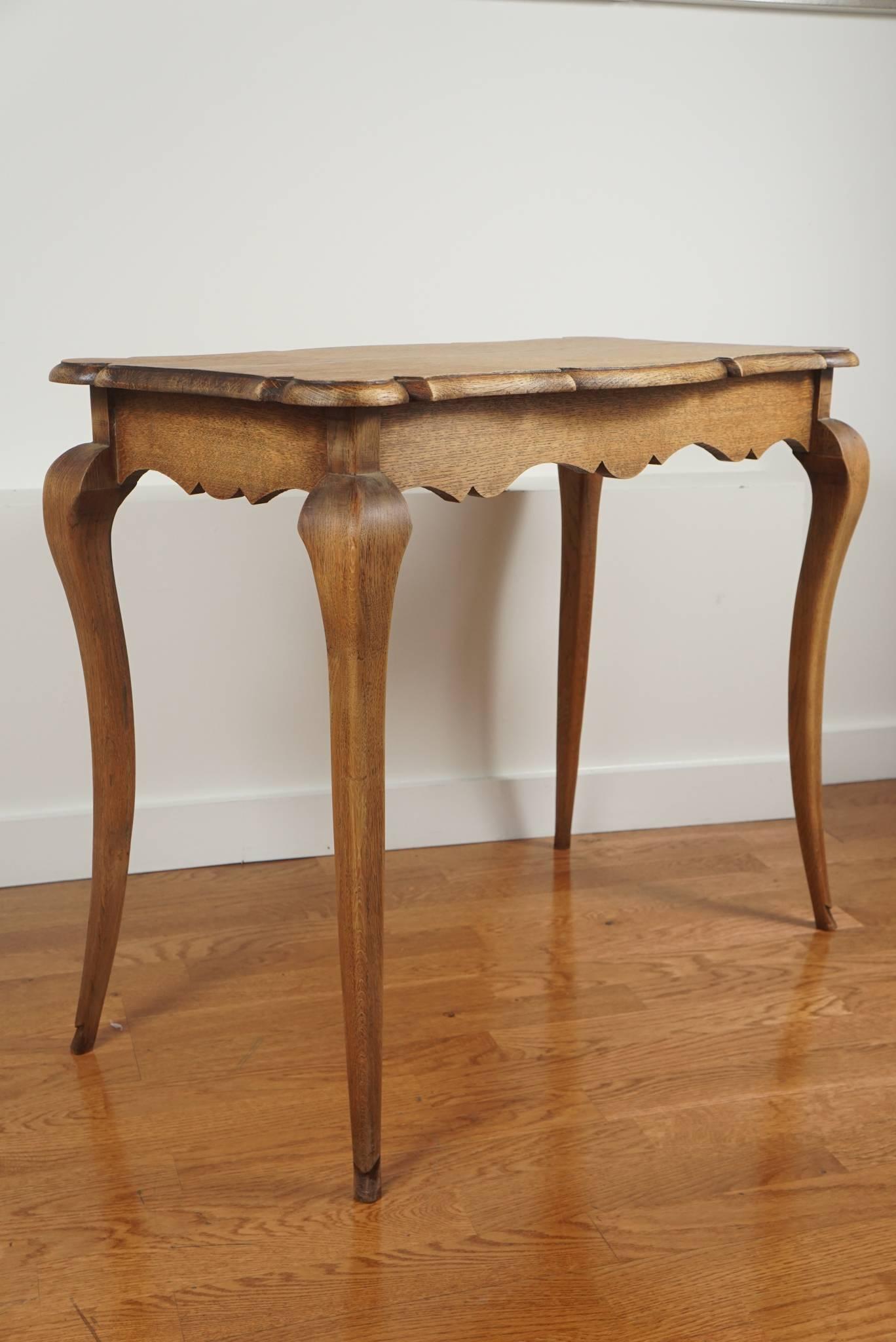 Graceful, French oak table, with apron sides, pie crust top, and simple cabriole legs a real charmer!