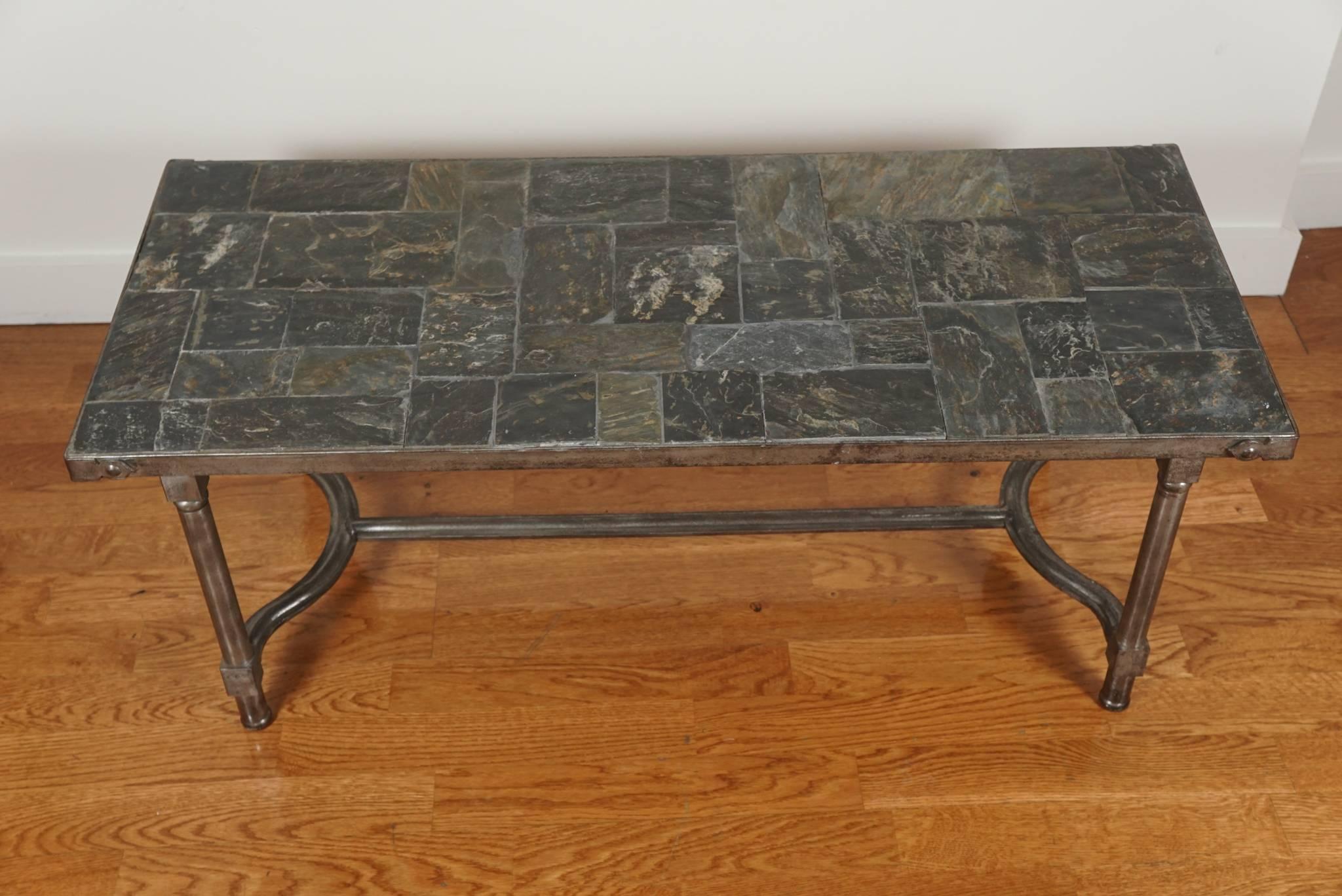 French, Low metal cocktail table, with a handsome slate top and a metal base
