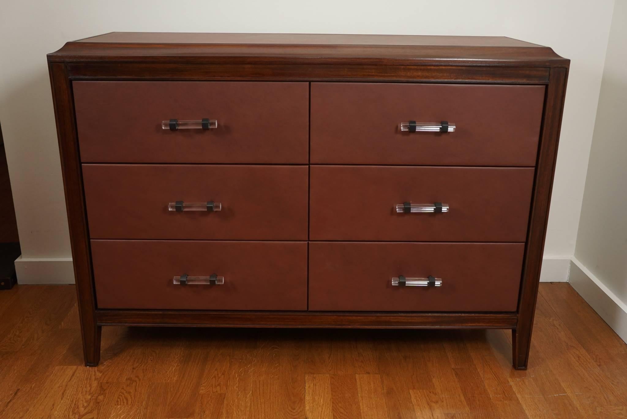 Handsome, custom dresser, shown in a light walnut wood frame, with inset leather top and nine leather wrapped drawer fronts. Subtle hardware pulls in Lucite with oil rubbed bronze hexagon rings.

Custom size and finish available.
10-12 week lead