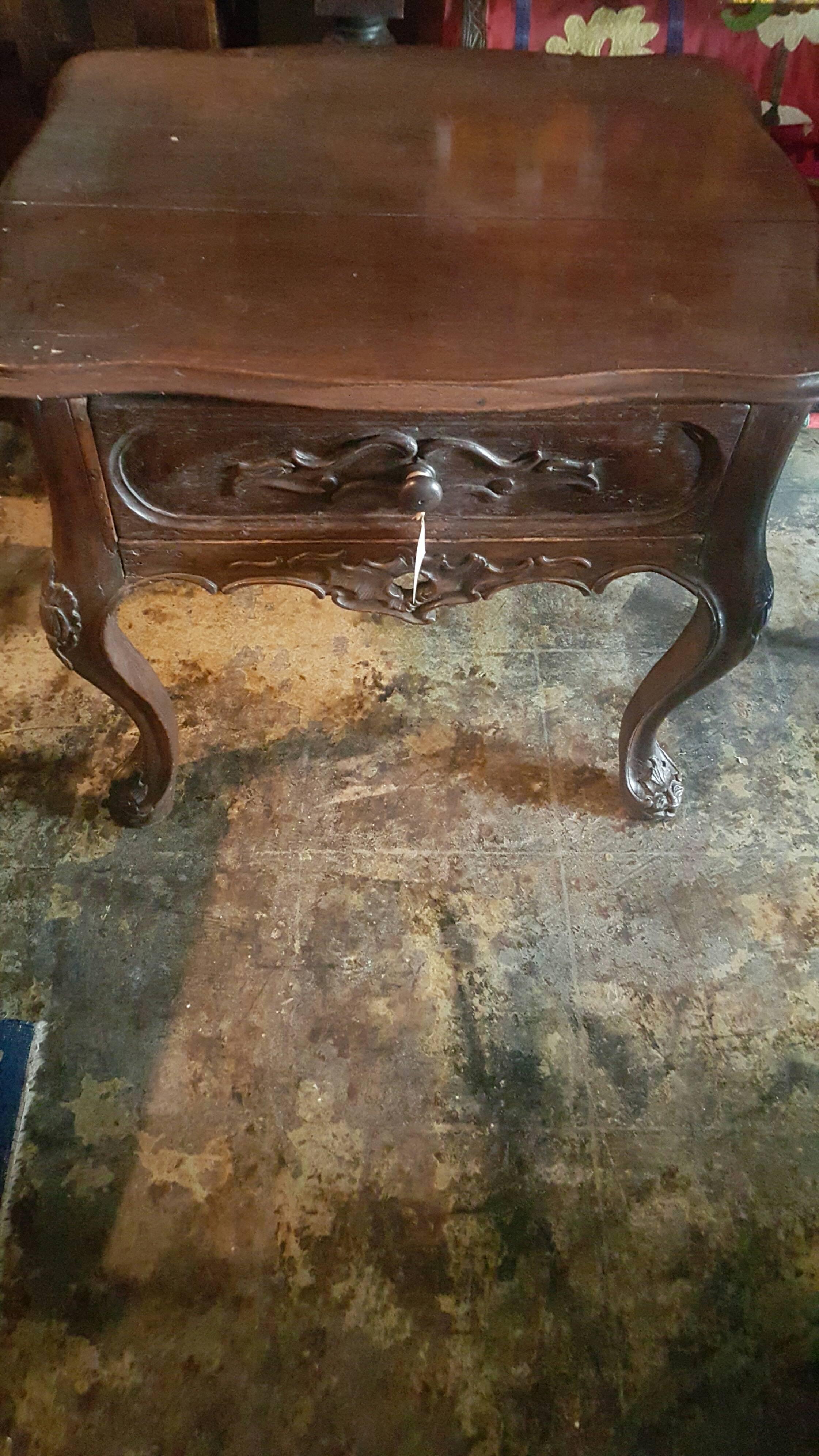 Portuguese occasional or side table with finely carved detail and one drawer.
