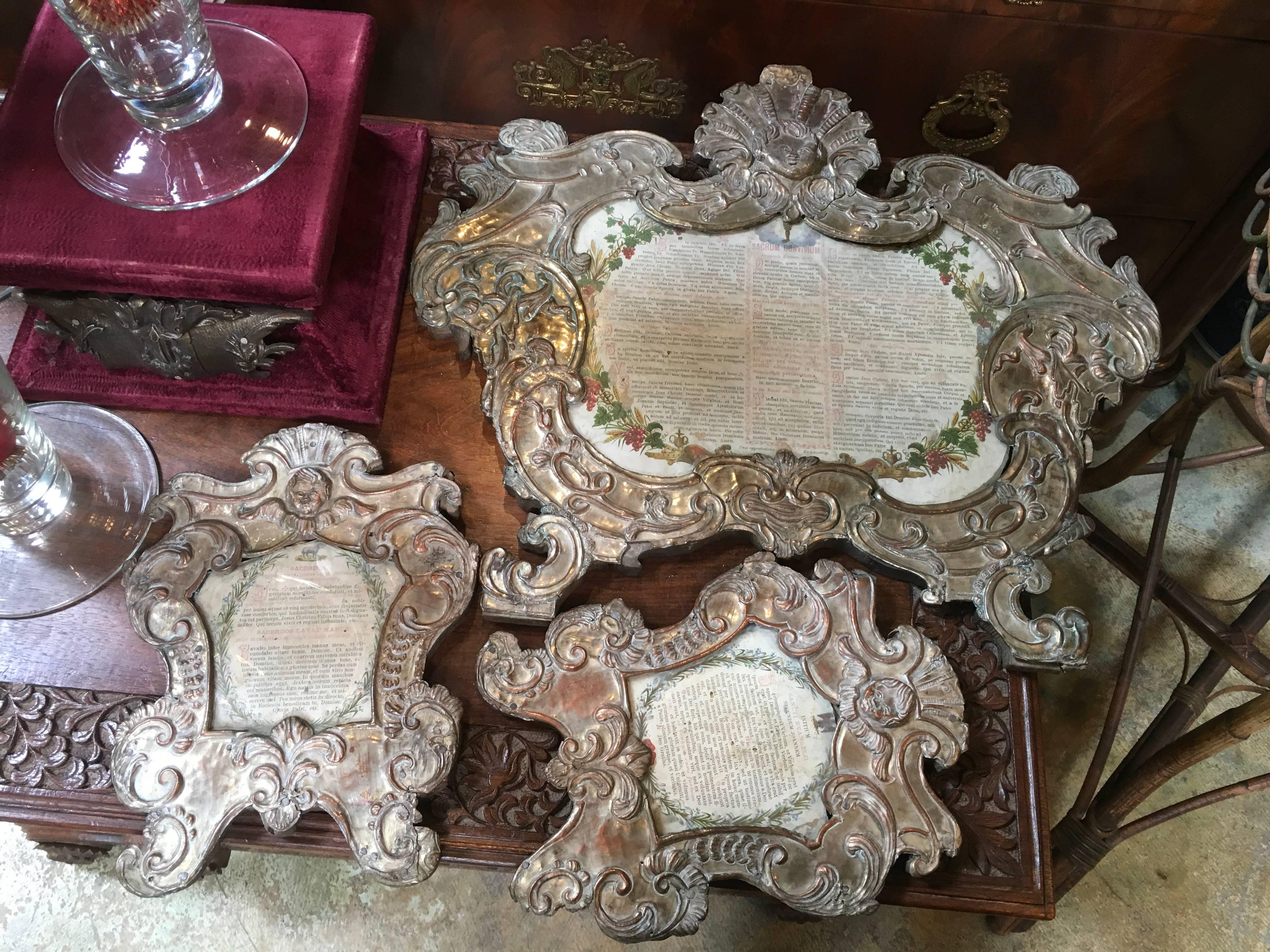 Set of three 18th century French Reliquaries.
Carved wood with metal repousse over the wood
Each piece contains the original Latin pages framed in original glass
These were used by the Catholics and represented relics used for prayers and