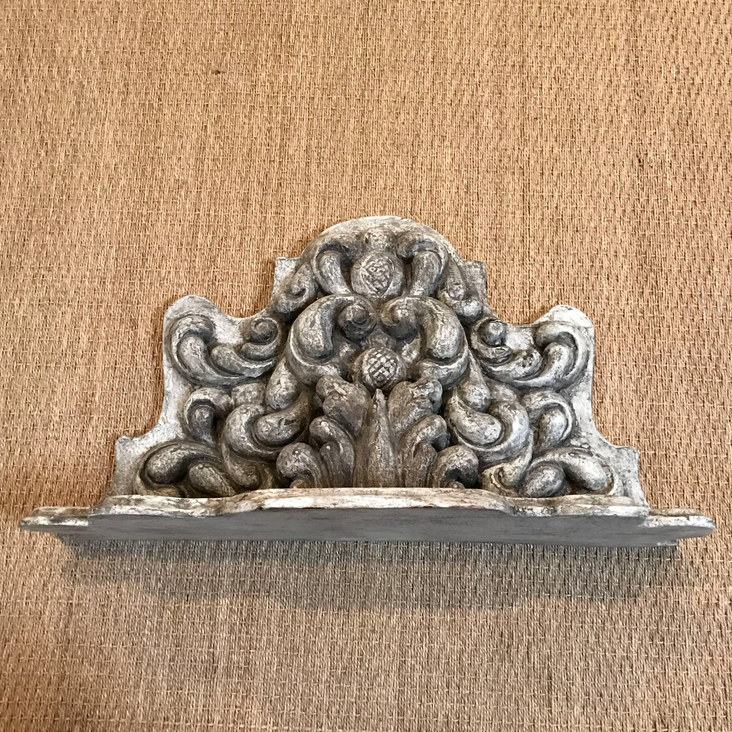 Wall bracket with ornately carved details
Finish is antique white and glazed.
