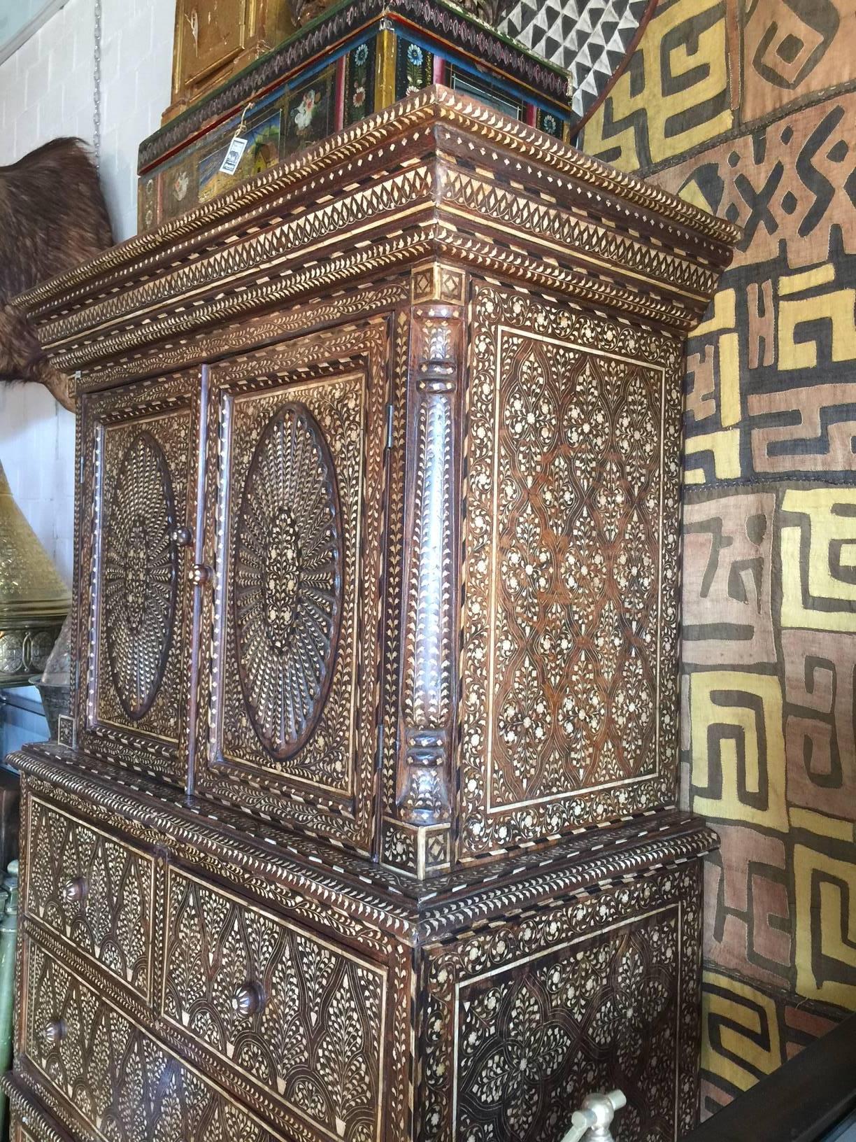 Vintage Indian Inlaid tall cabinet with five drawers.
Cabinet with oval inlaid decorative doors
Exceptional details.