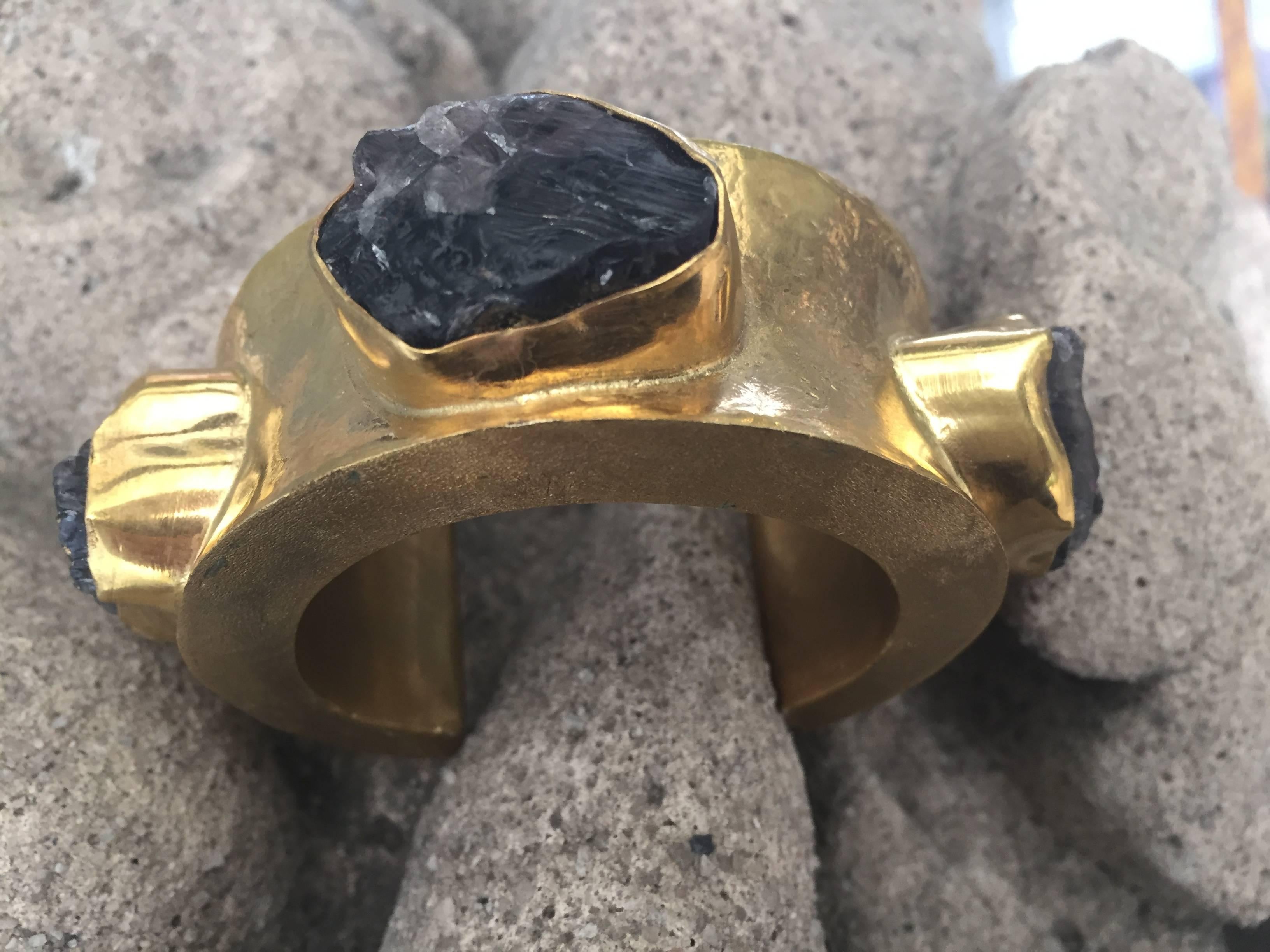 Large cuff bracelet designed by Michelle Nussbaumer

Bronze dipped in 22-carat gold

Black rock crystal stones.

 