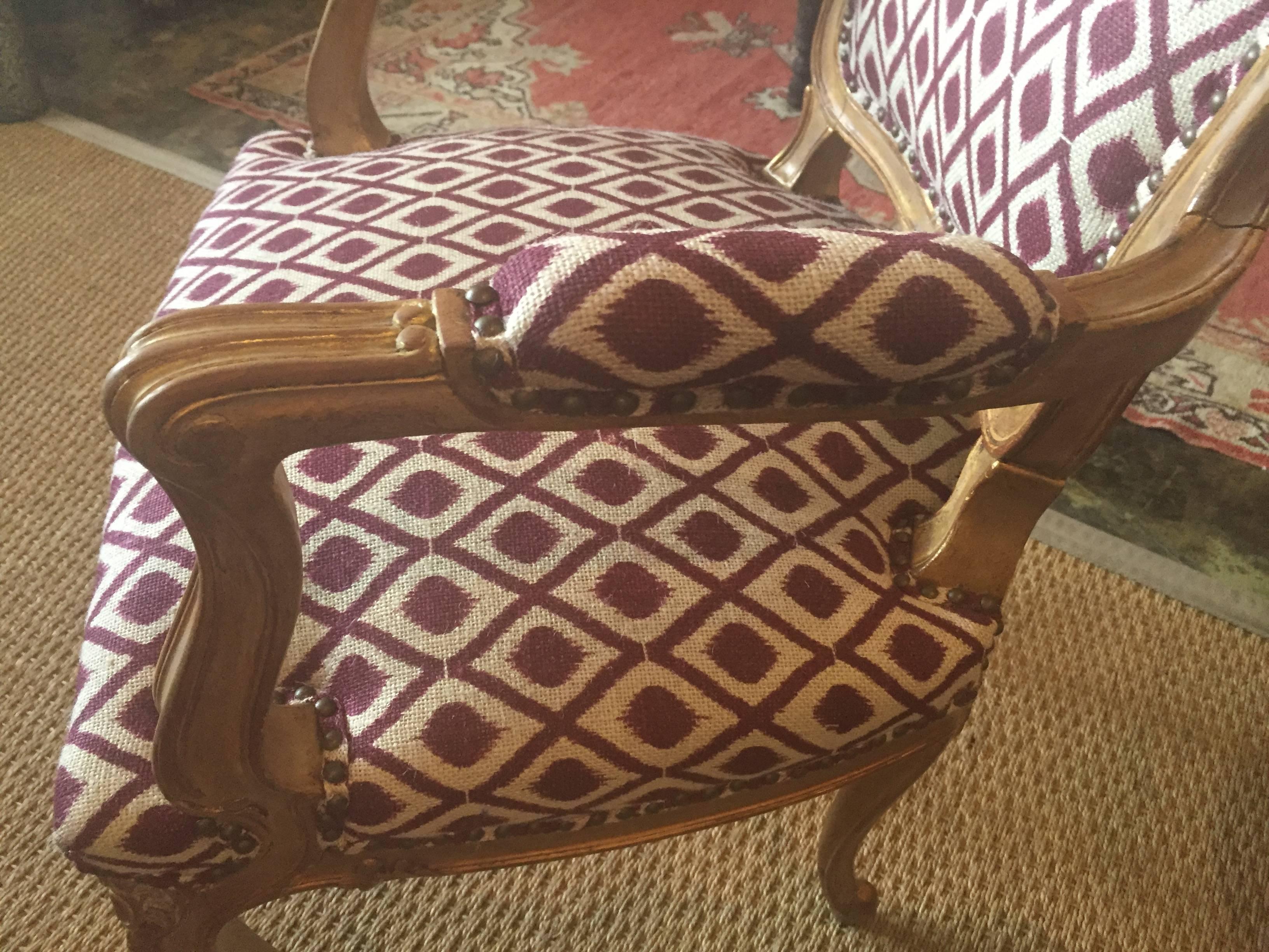Pair of Louis XV fauteuils with original nail trim.
Finish is rubbed with 24-karat gold leaf in carving.
 