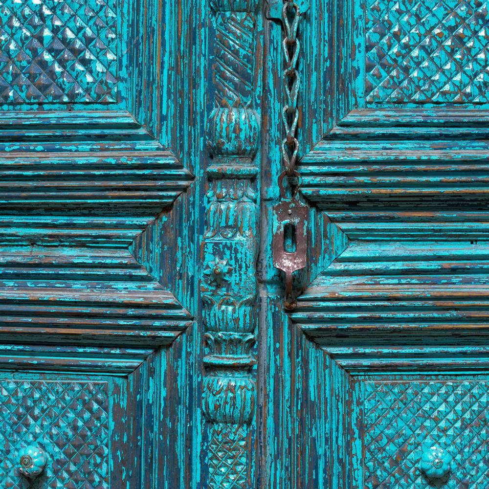 Rajasthani style cabinet of recent manufacture. The front is composed from a reclaimed, hand-carved, converted doorway dating from the late 19th or early 20th century.  