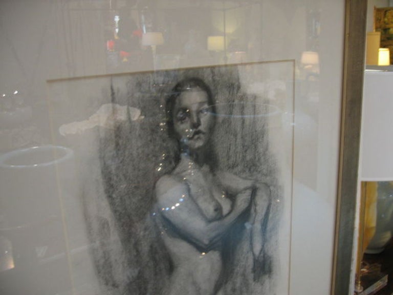A beautiful charcoal drawing, one of a pair. Model is facing to her left. Custom matted and framed in a contemporary silver-leaf frame with glass.