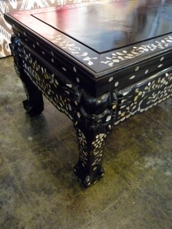 Cocktail table with mother-of-pearl inlay design. Hand-carved legs.