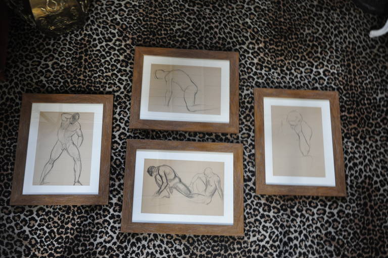 1940s nude male drawings in charcoal matted and framed. These drawings are matted in a neutral color with a rustic wood frame.