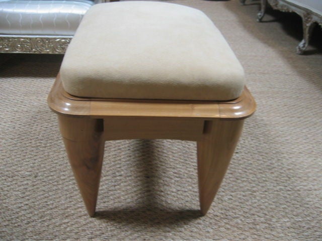 French stool with tapering legs and sinuous curved details. Suede upholstery.