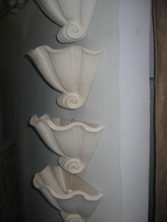 Set of four plaster wall sconces by Serge Roche.