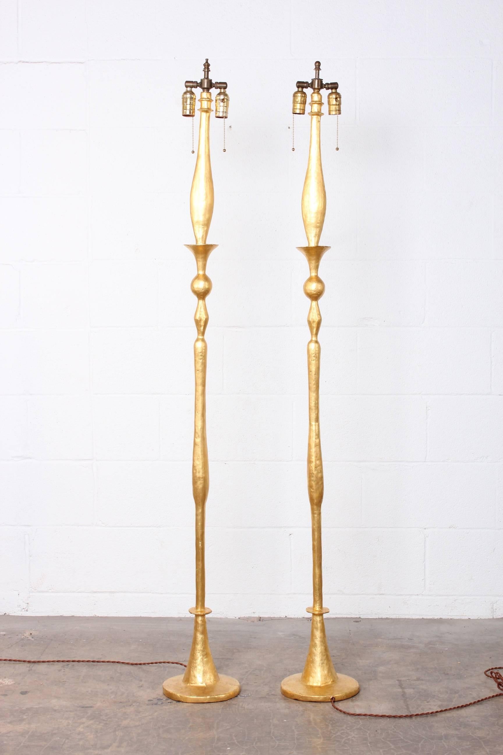 A pair of authorized limited edition reissue floor lamps in gilded solid bronze by Alberto Giacometti from the 1978 Nelson Rockefeller collection.
 