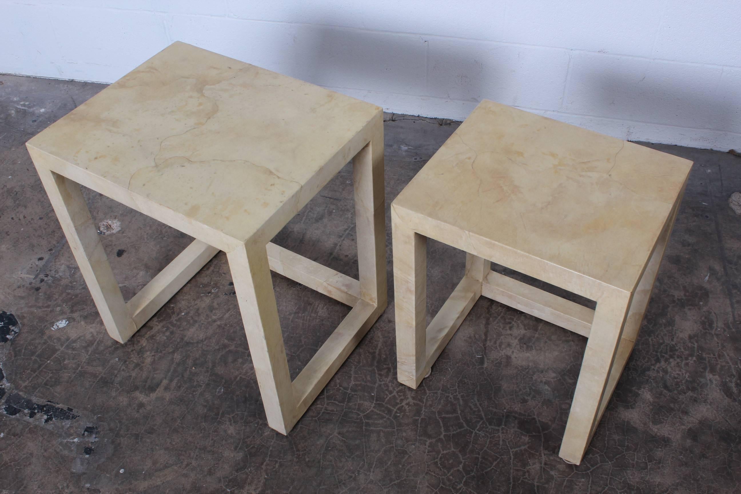 A pair of parchment covered nesting tables designed by Karl Springer.