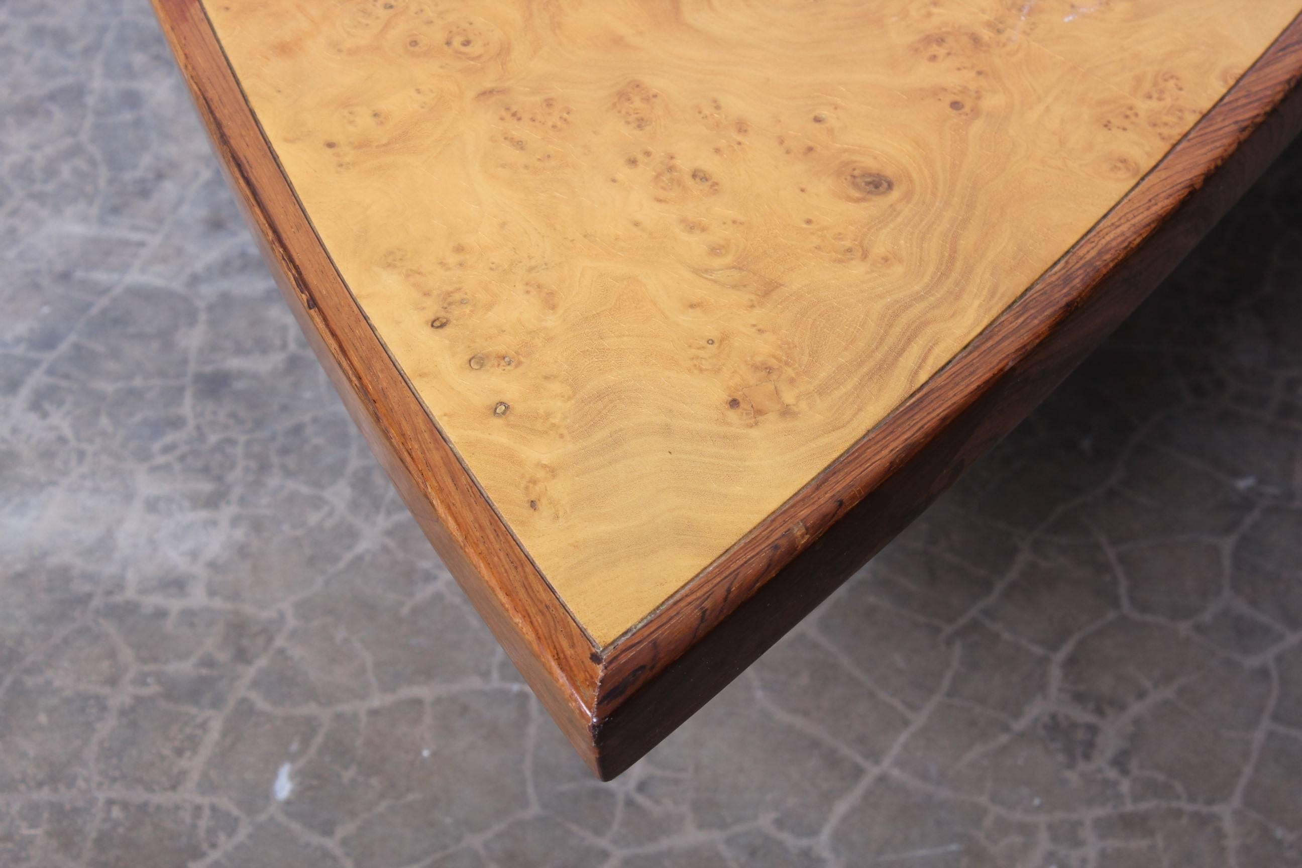 A large coffee table made of solid rosewood and carpathian elm. Designed by George Nakashima for Widdicomb.