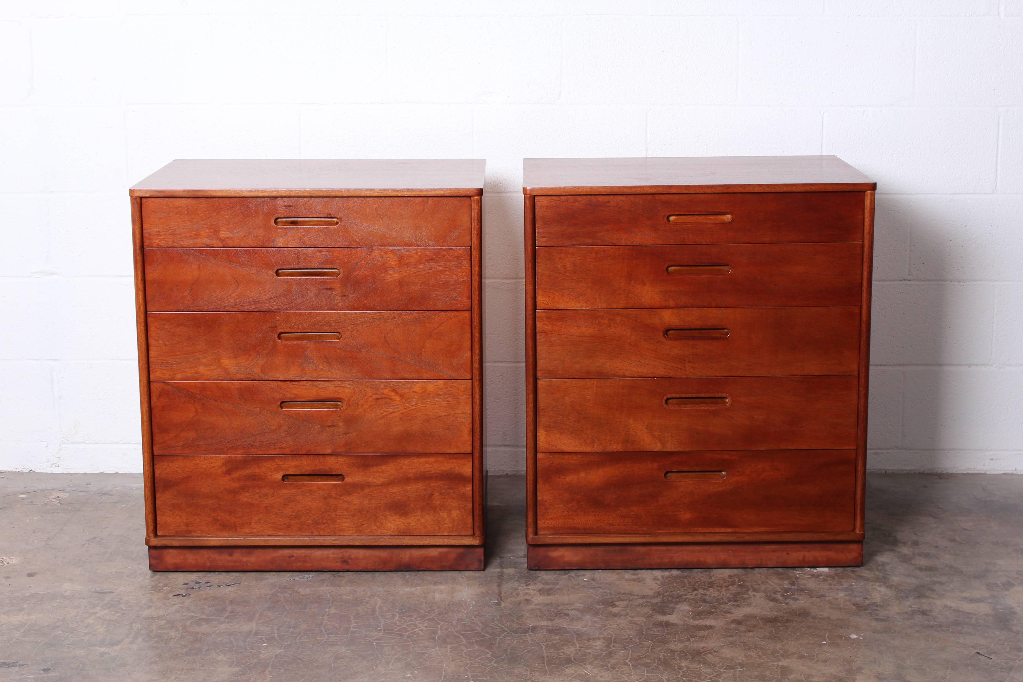 A pair of mahogany bedside tables or dressers with leather wrapped plinth bases. Designed by Edward Wormley for Dunbar.