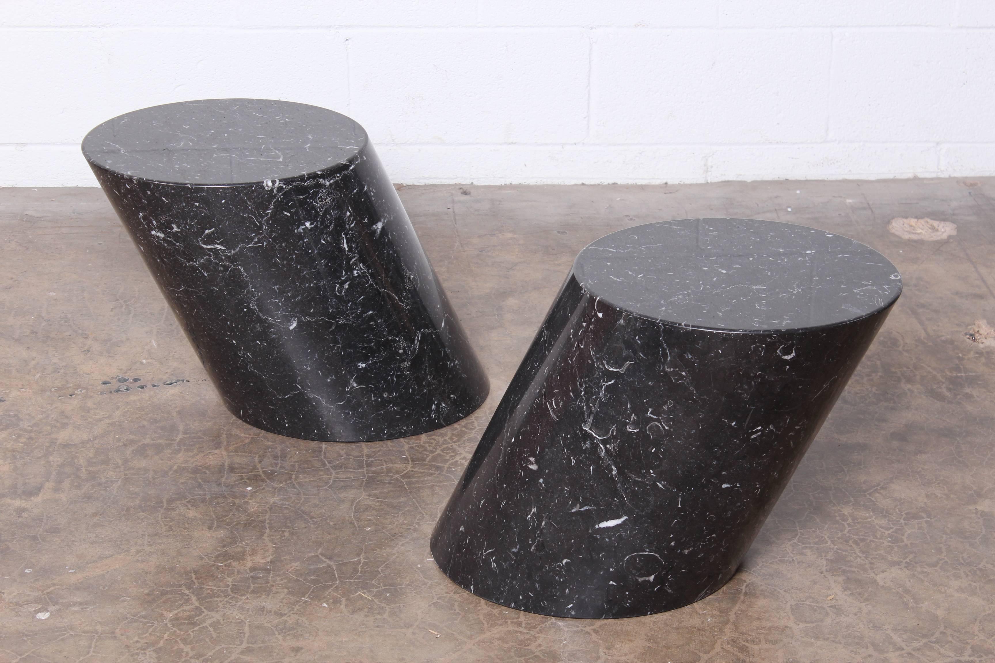 A pair of solid marble stump tables designed by Lucia Mercer for Knoll.