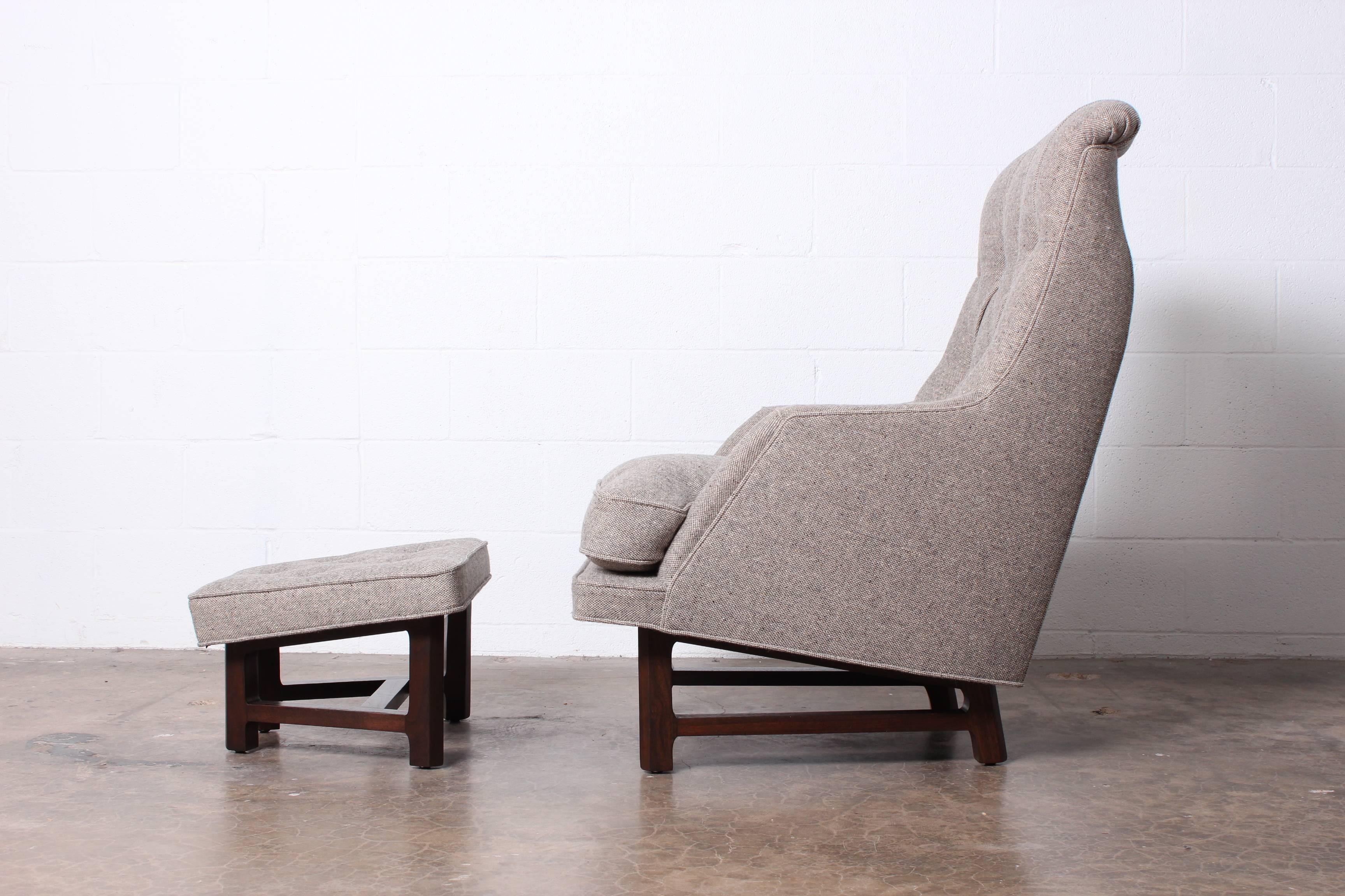 A rare lounge chair and ottoman with mahogany base and Maharam wool upholstery. Designed by Edward Wormley for Dunbar.