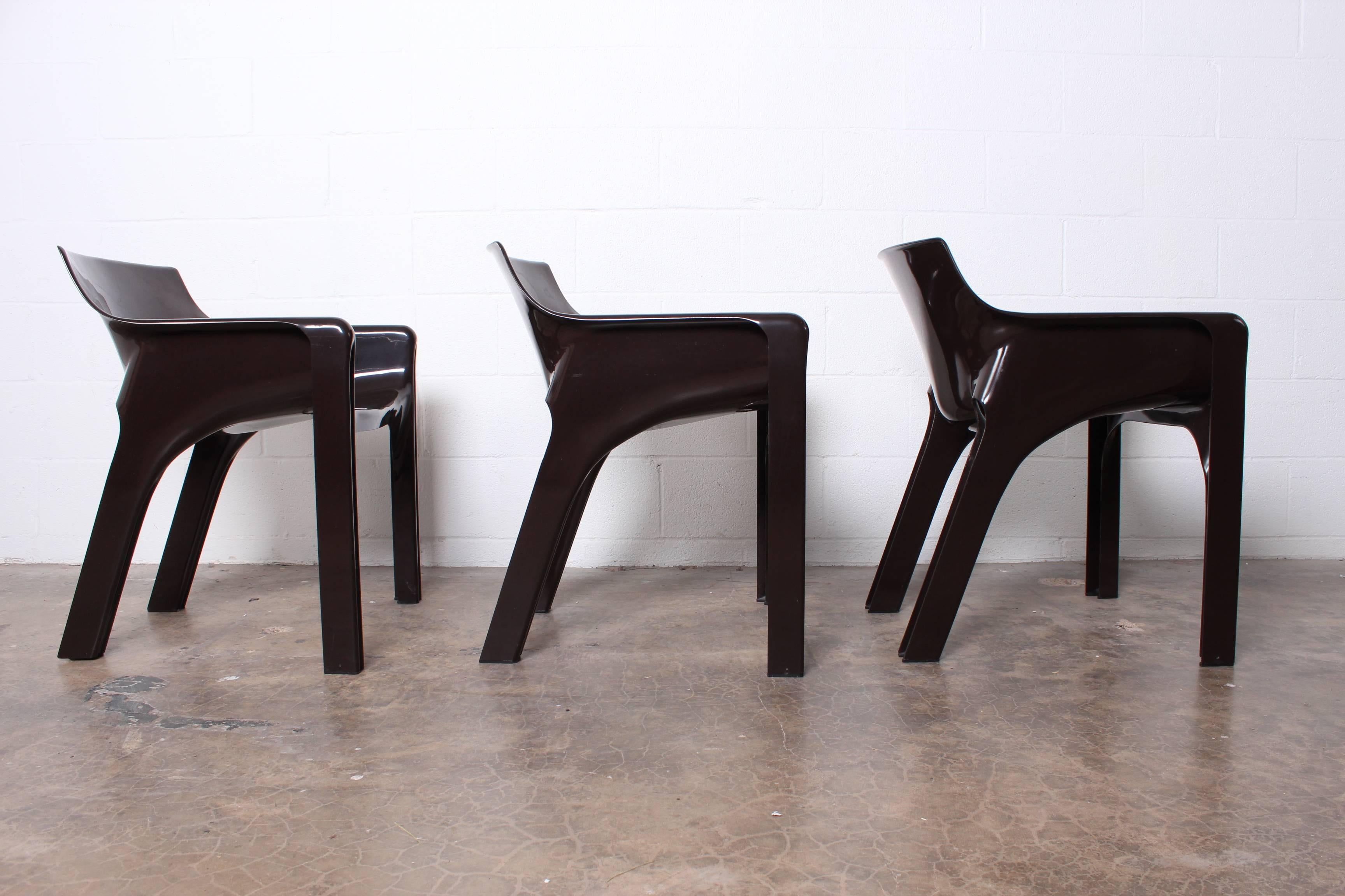 A set of six brown Gaudi armchairs designed by Vico Magistretti for Artemide.